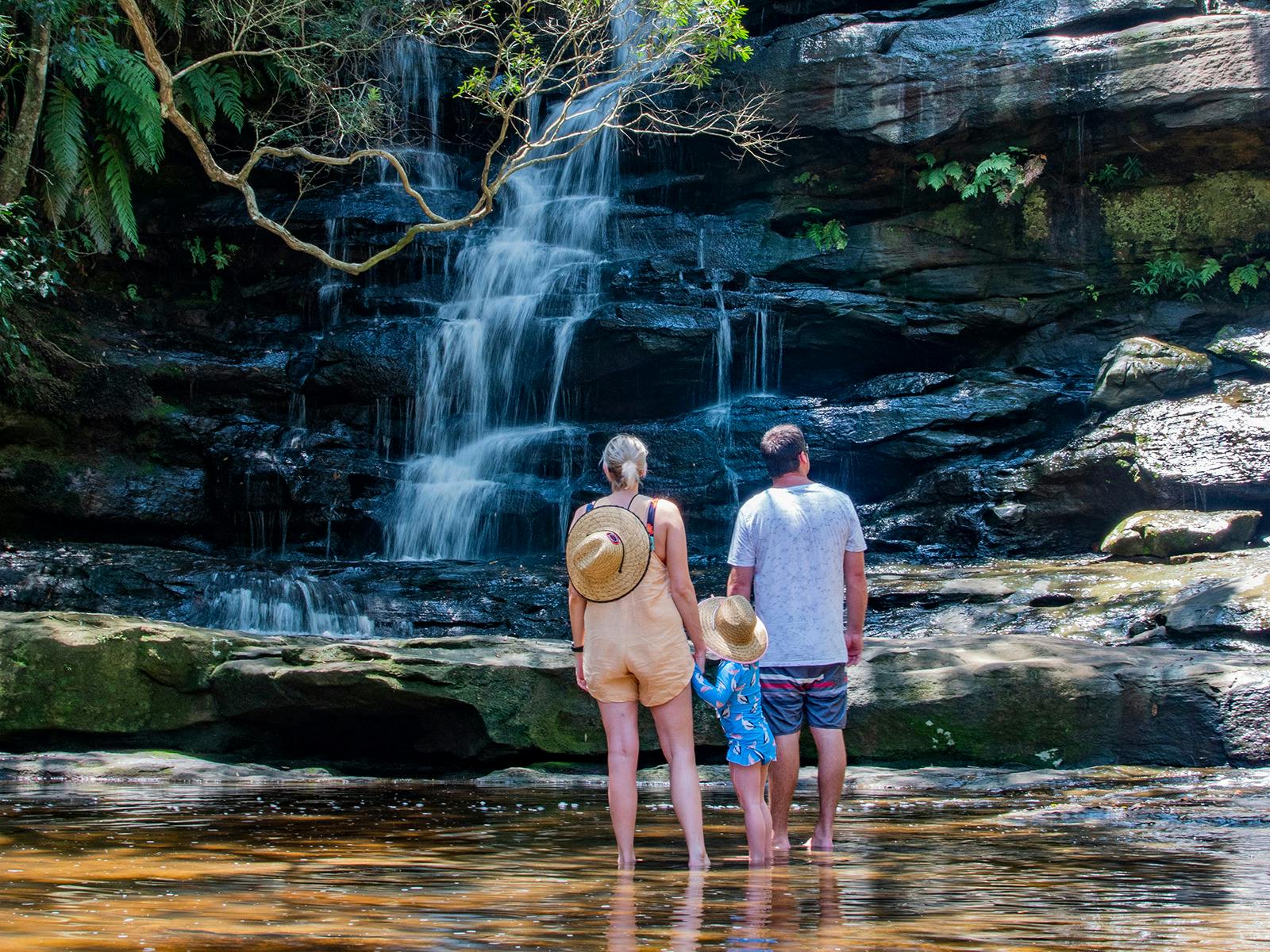 Family near waterfall