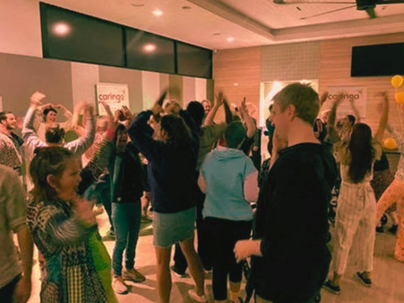 Participants gather for an accessible choir session, singing and moving in a fun inclusive way