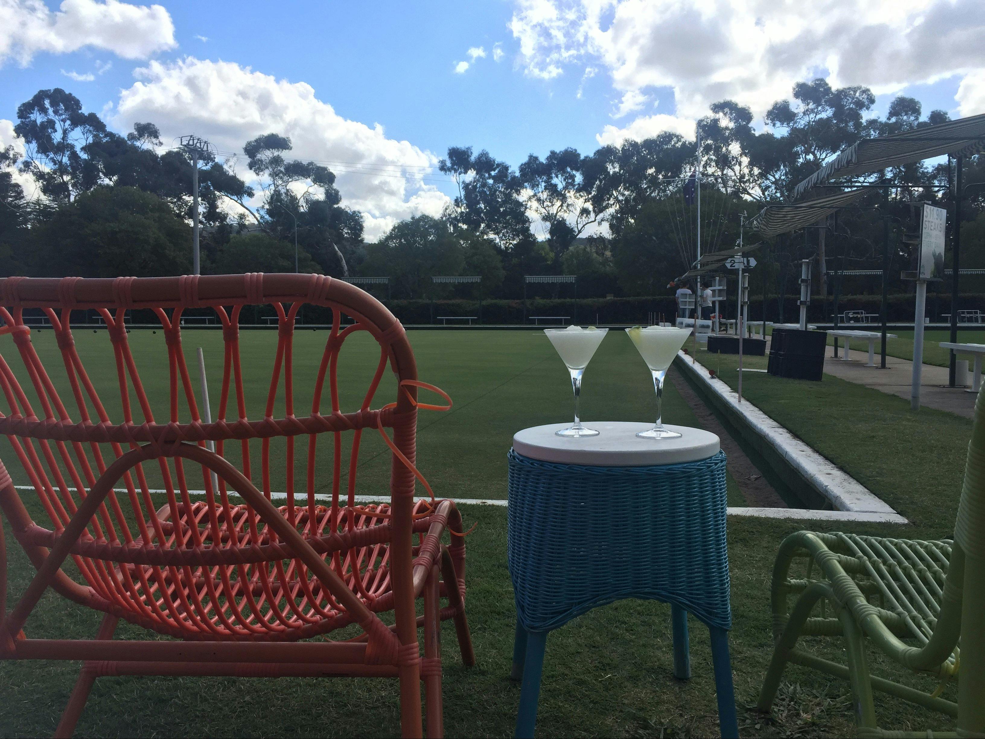 Comfortable chairs and cocktails by the greens