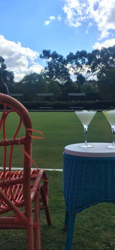 Comfortable chairs and cocktails by the greens