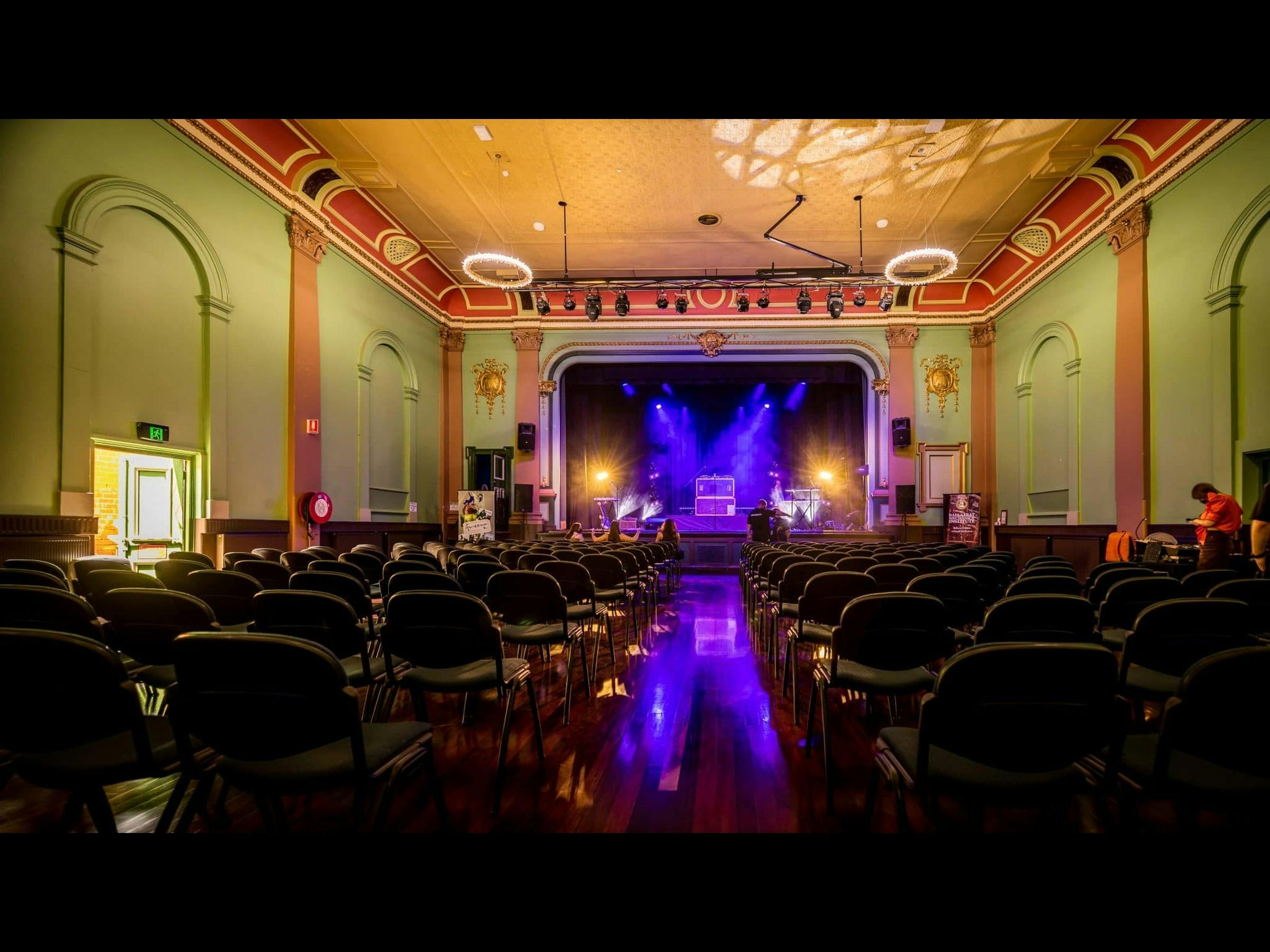 Interior of the Ballarat Mechanics Institute theatre, with rows of seating facing the stage.