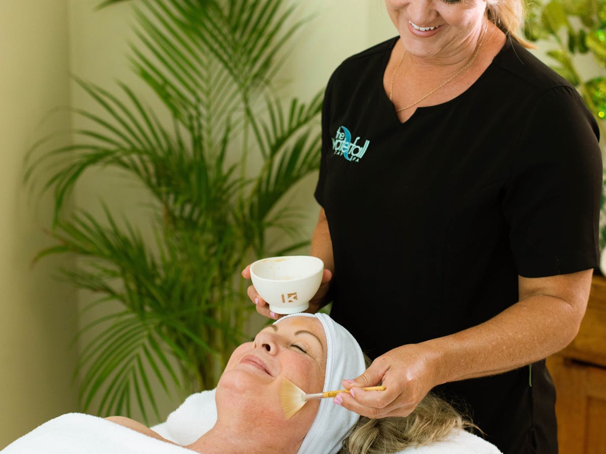 Woman getting a facial using kphyto products