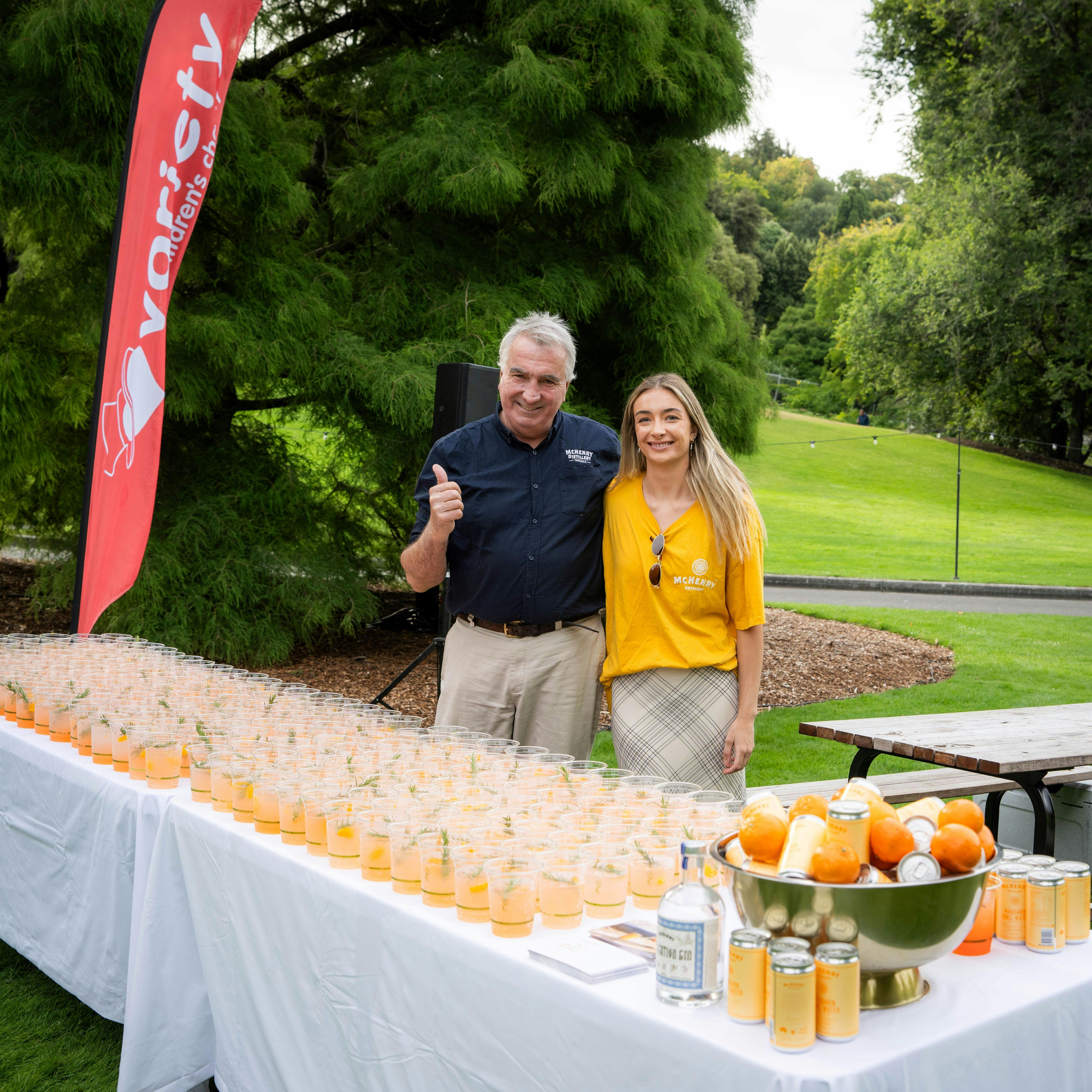 William McHenry and his daughter Lucy in front of a table of gin cocktails