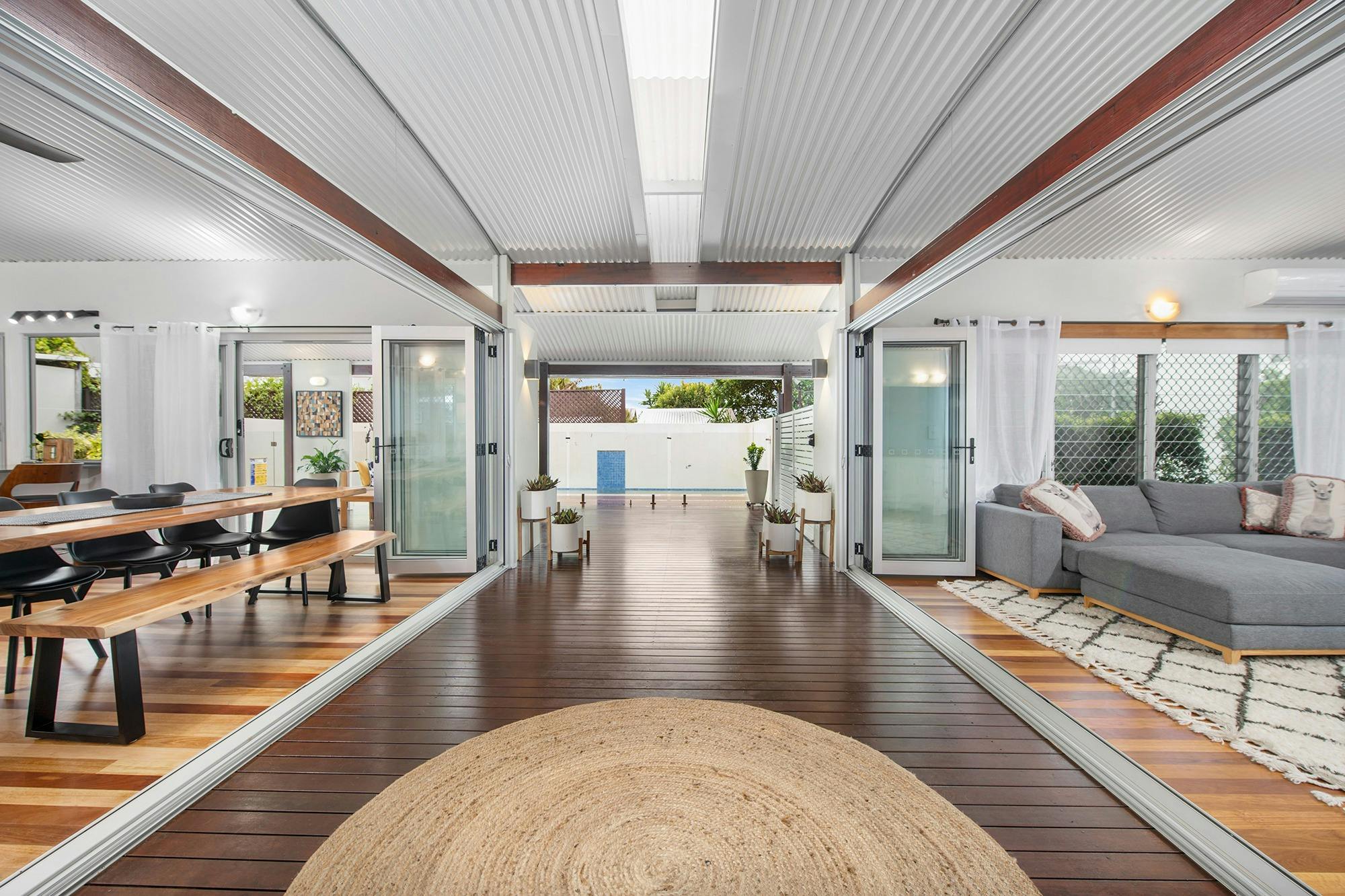 Step through the front door and into the Breezeway and take in the decks, pool, lounge  & dining