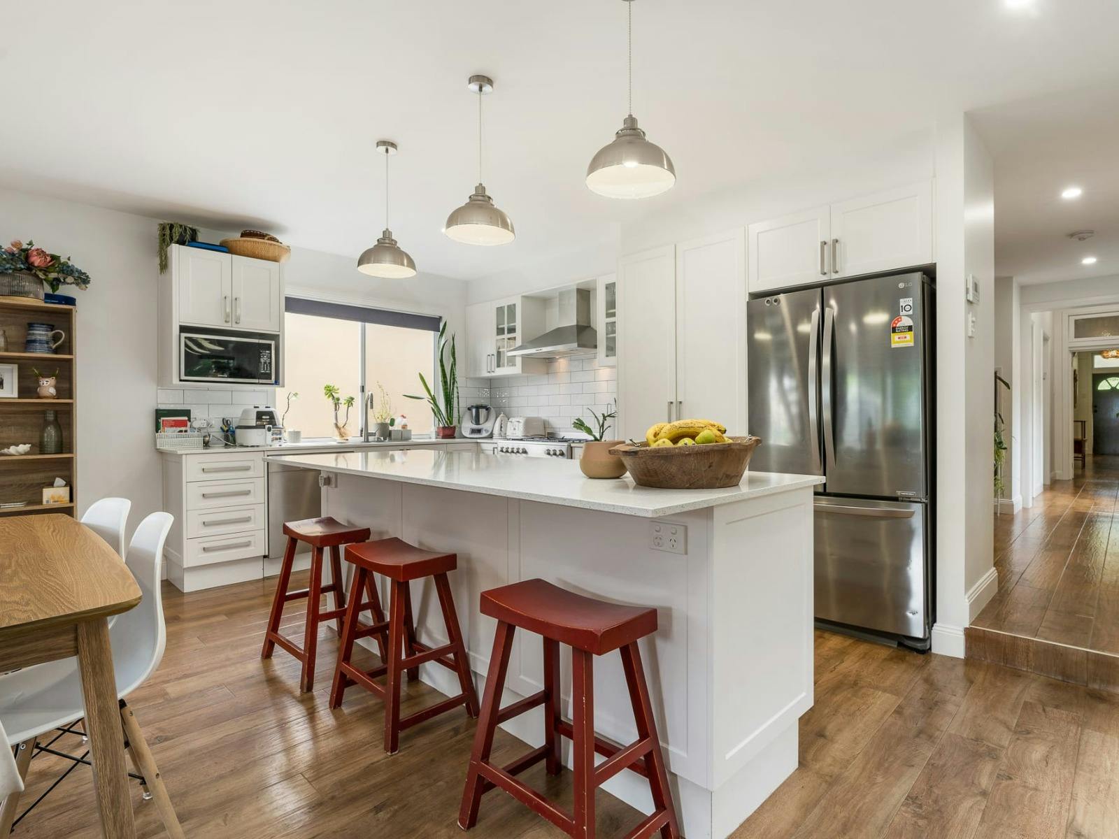 Large open kitchen with island bench and bar stools