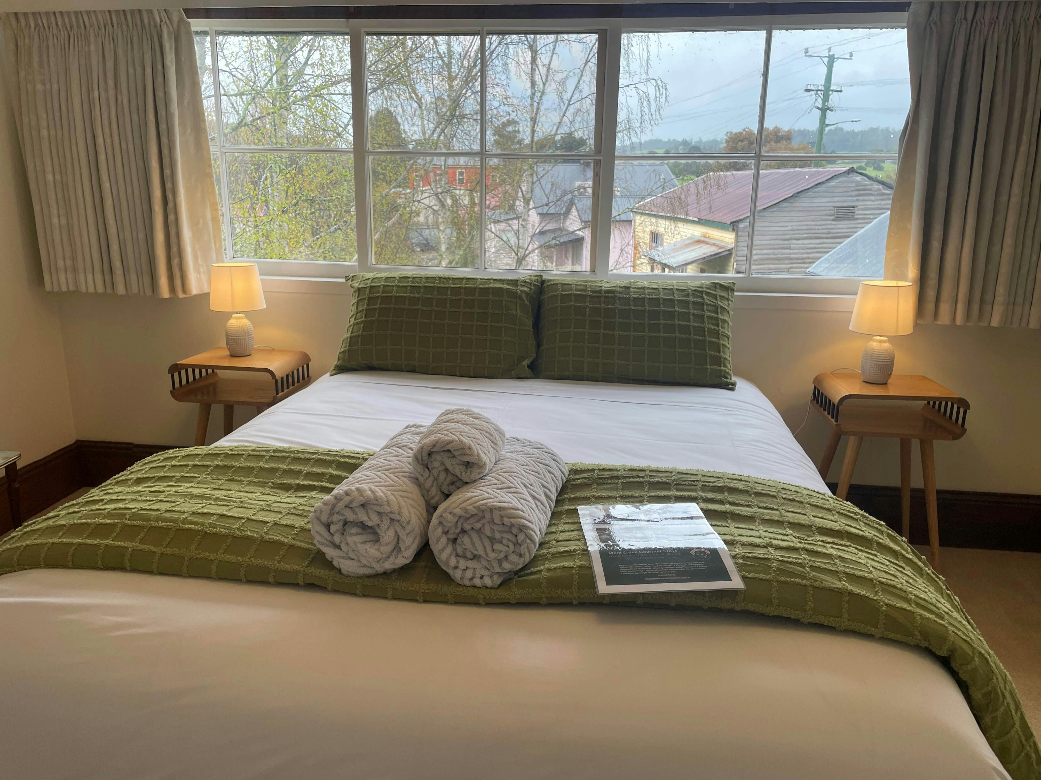 comfortable bed with view over rural village from the large window.