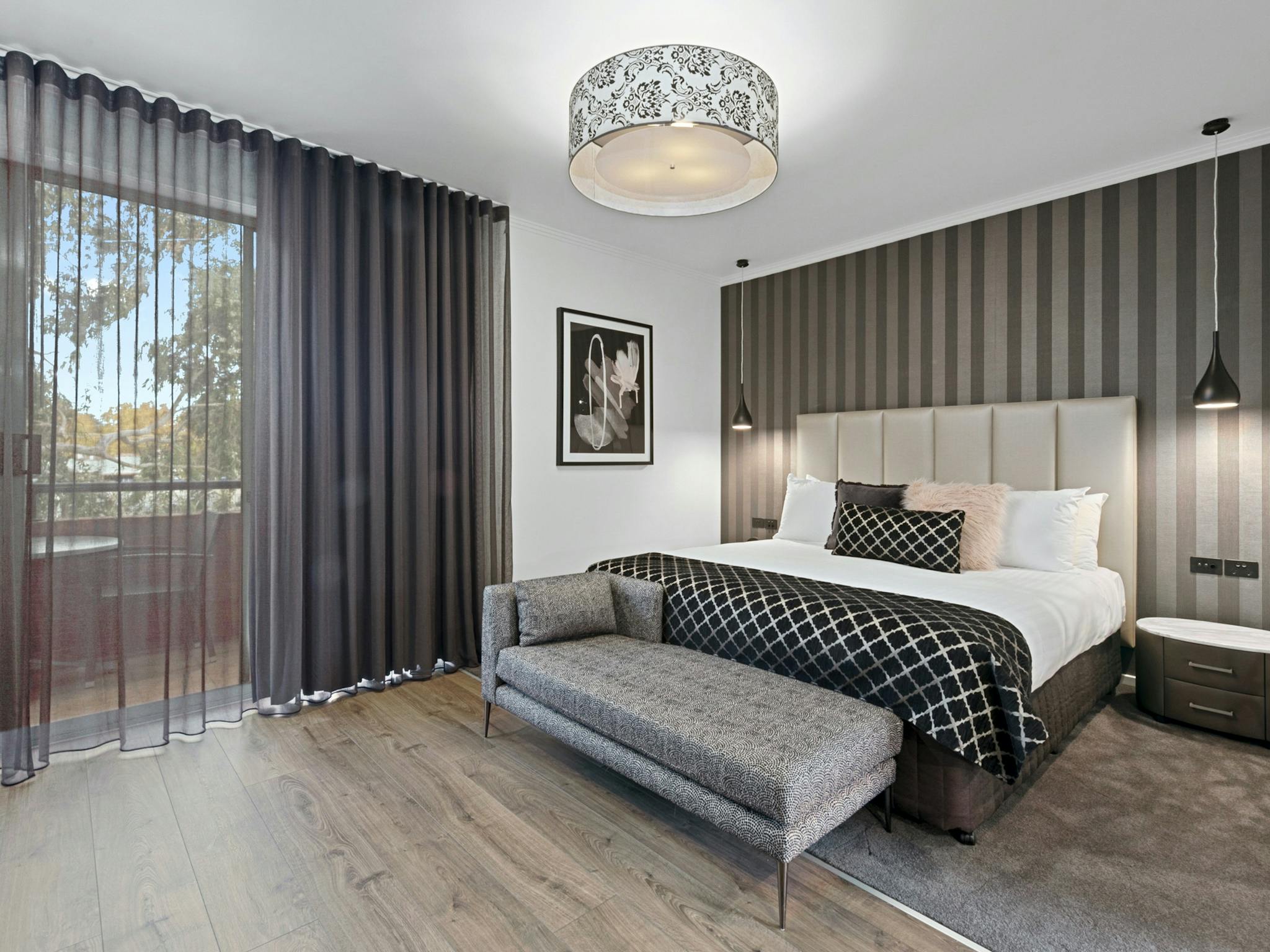 Modern, renovated bedroom looking out to private balcony