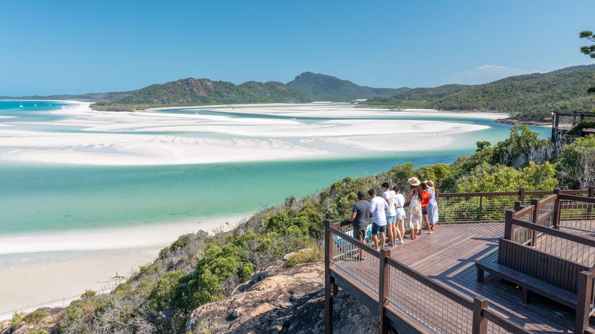 Group of people looking at the beautiful swirling sands of Hill Inlet