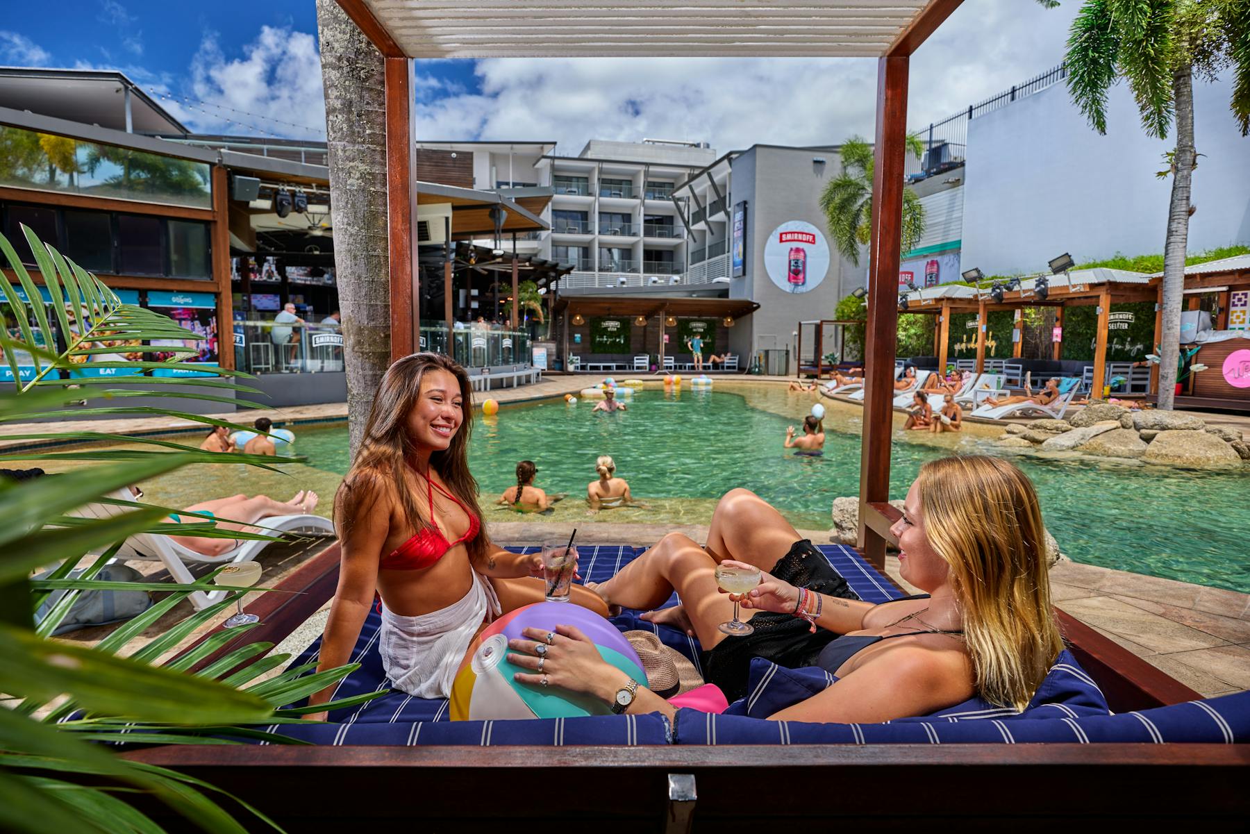 Pool area with sun loungers, cabanas and bar
