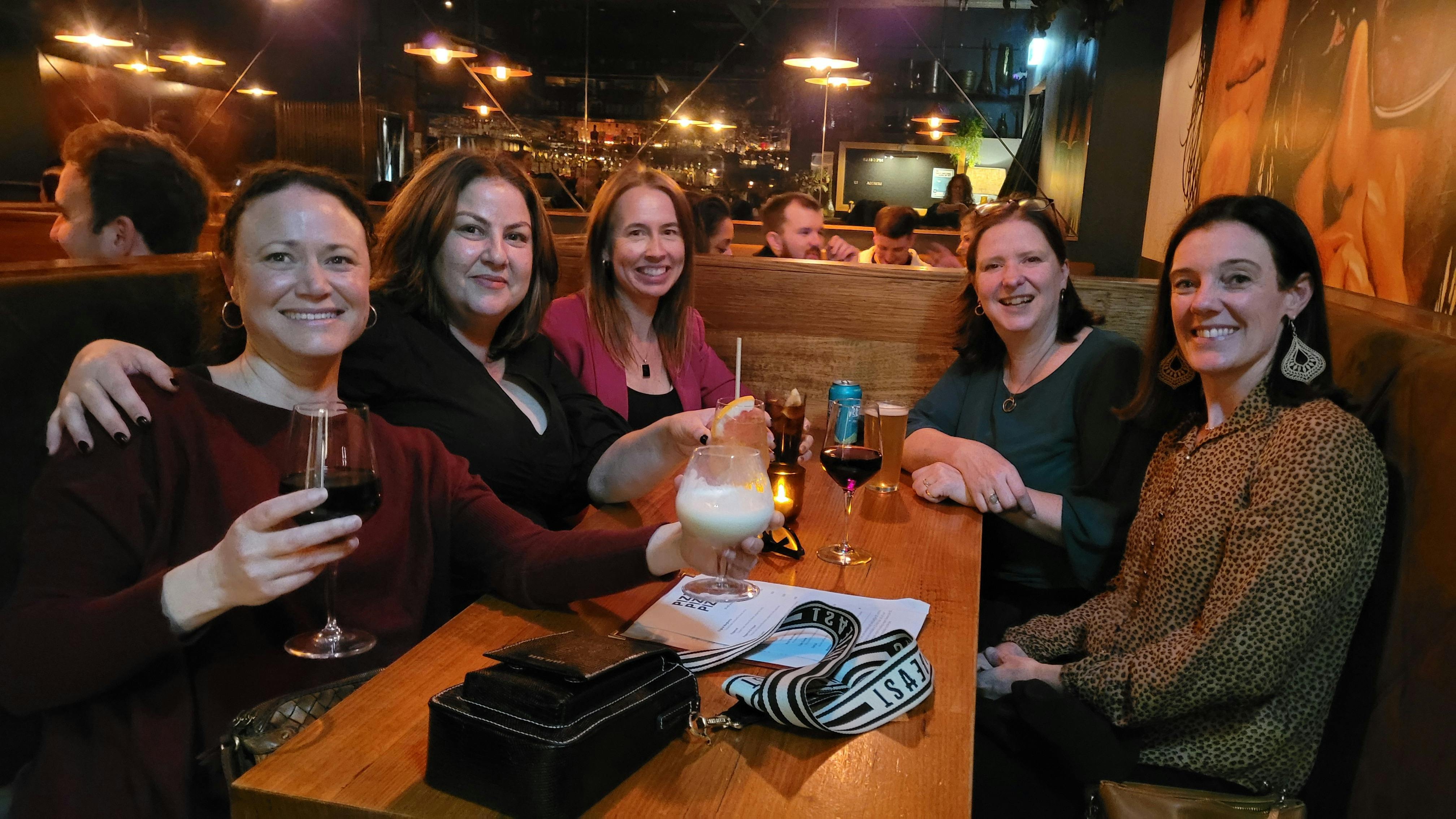 A group of women sipping on cocktails
