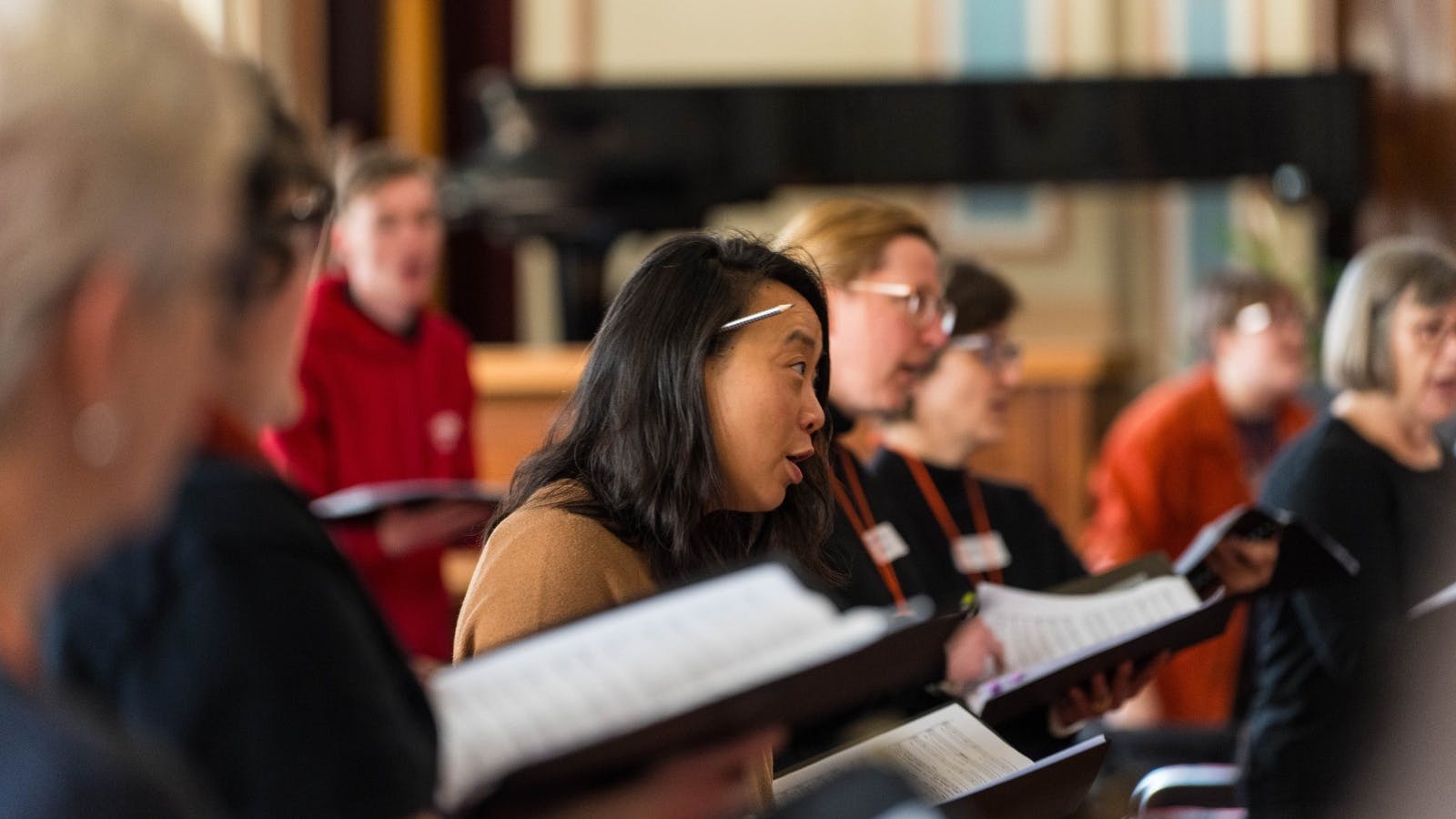 Choral singers practicing sight-reading at a professional development session.