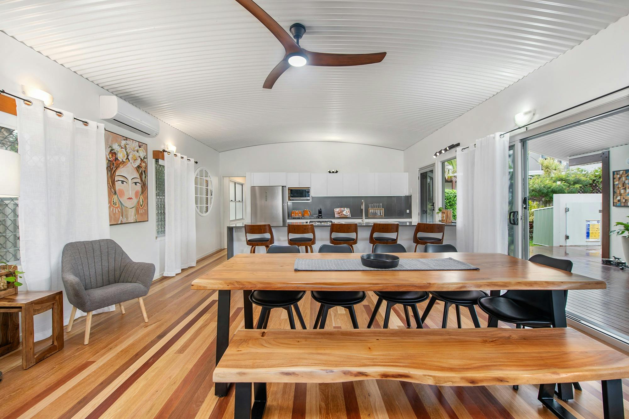 Dining table seats up 10 & bifold glass doors open up on to the breezeway to enjoy ocean breezes