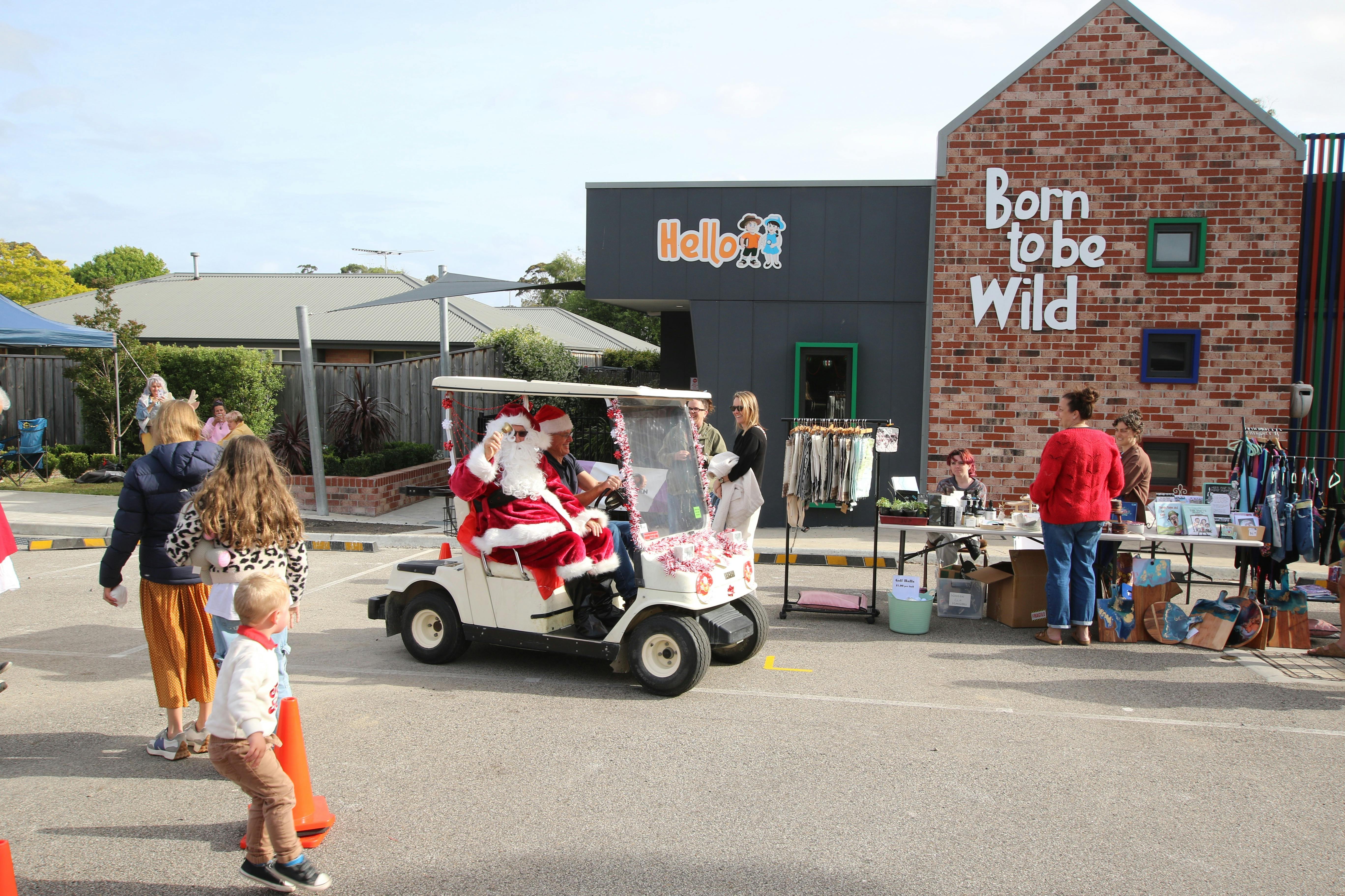 Santa arriving on a custom golf cart