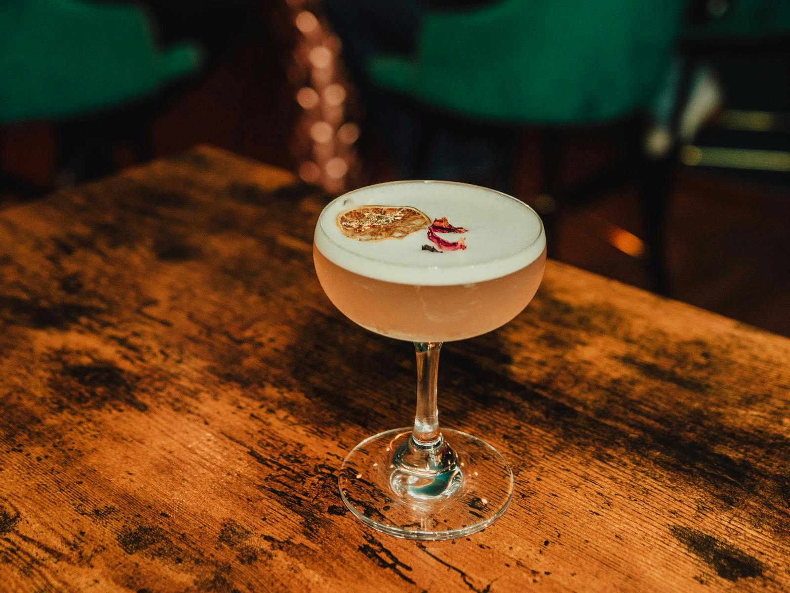 Delicious Cocktails served up at the bar, gin sour in coupe glass with garnish