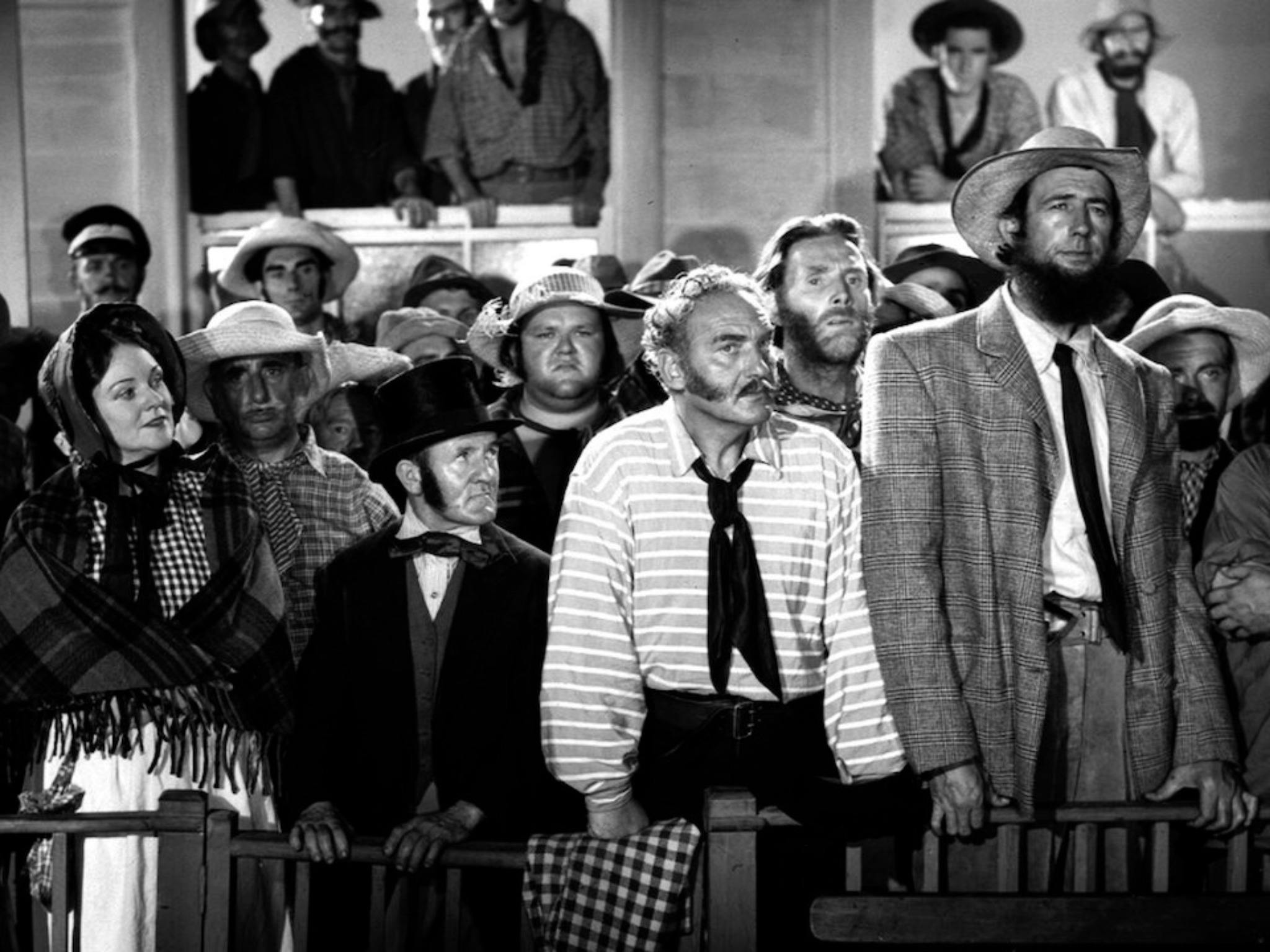 Black and white still from Eureka Stockade showing a group of people in period attire
