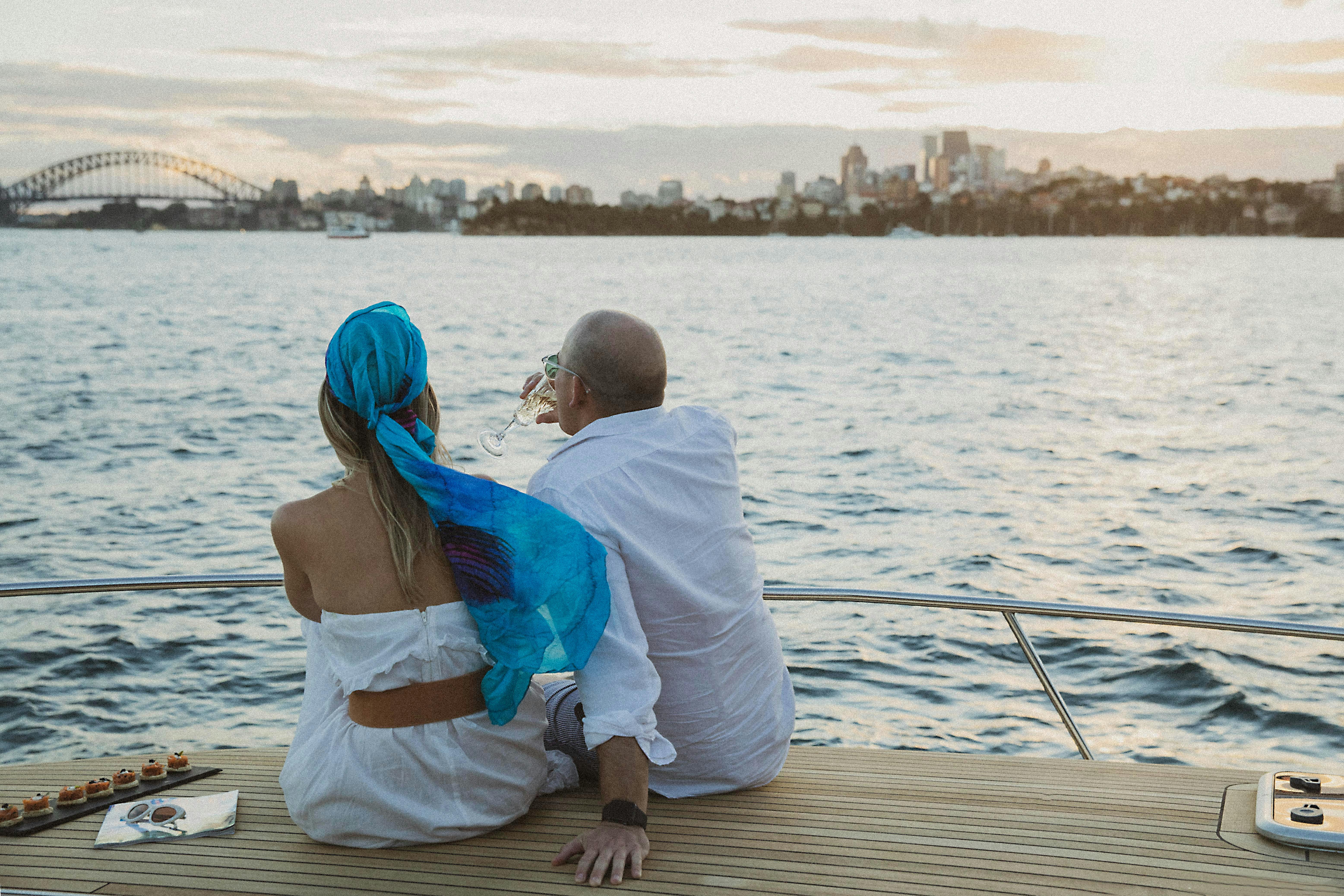 Couple sit on bow of boat
