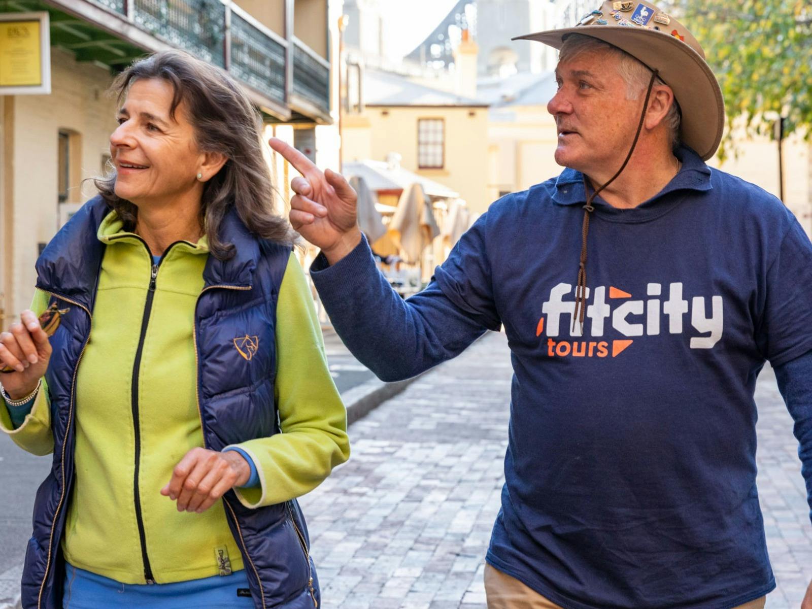 Tour guide explaining something to a smiling tour guest