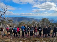 A group of hikers are soaking up the views of the Delatite Valley.