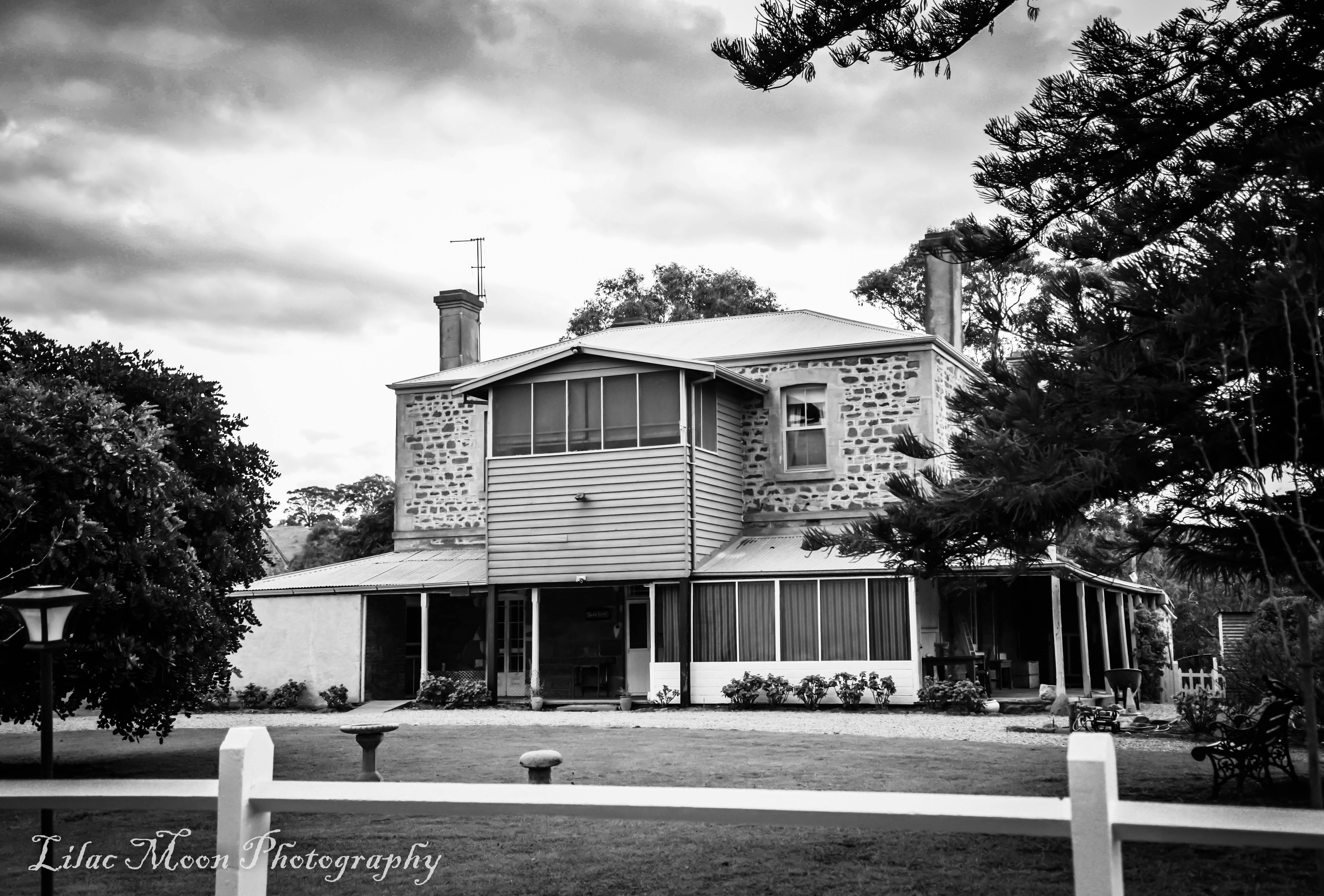 Distance view of Glenbarr Homestead in black and white.  2 story house.
