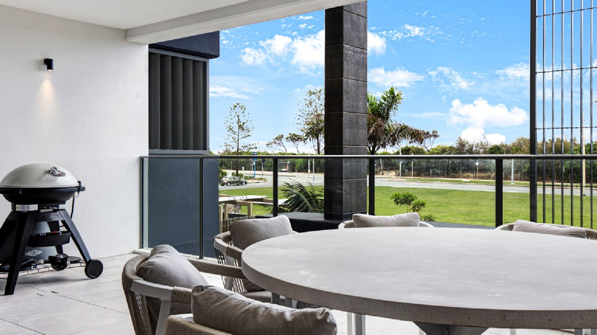Balcony area with outdoor dining and BBQ