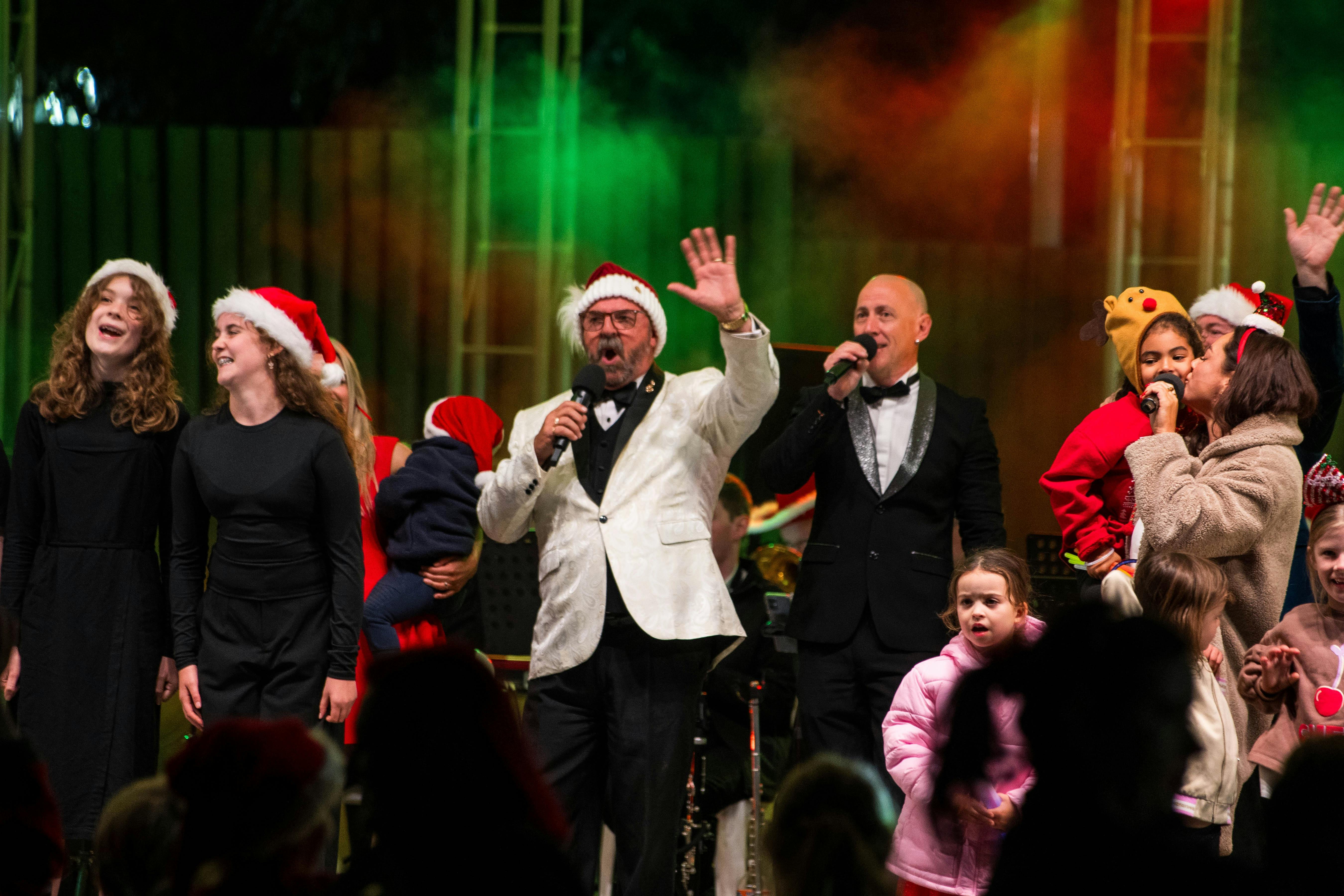 Performer John X singing the finale wtih kids and families on stage