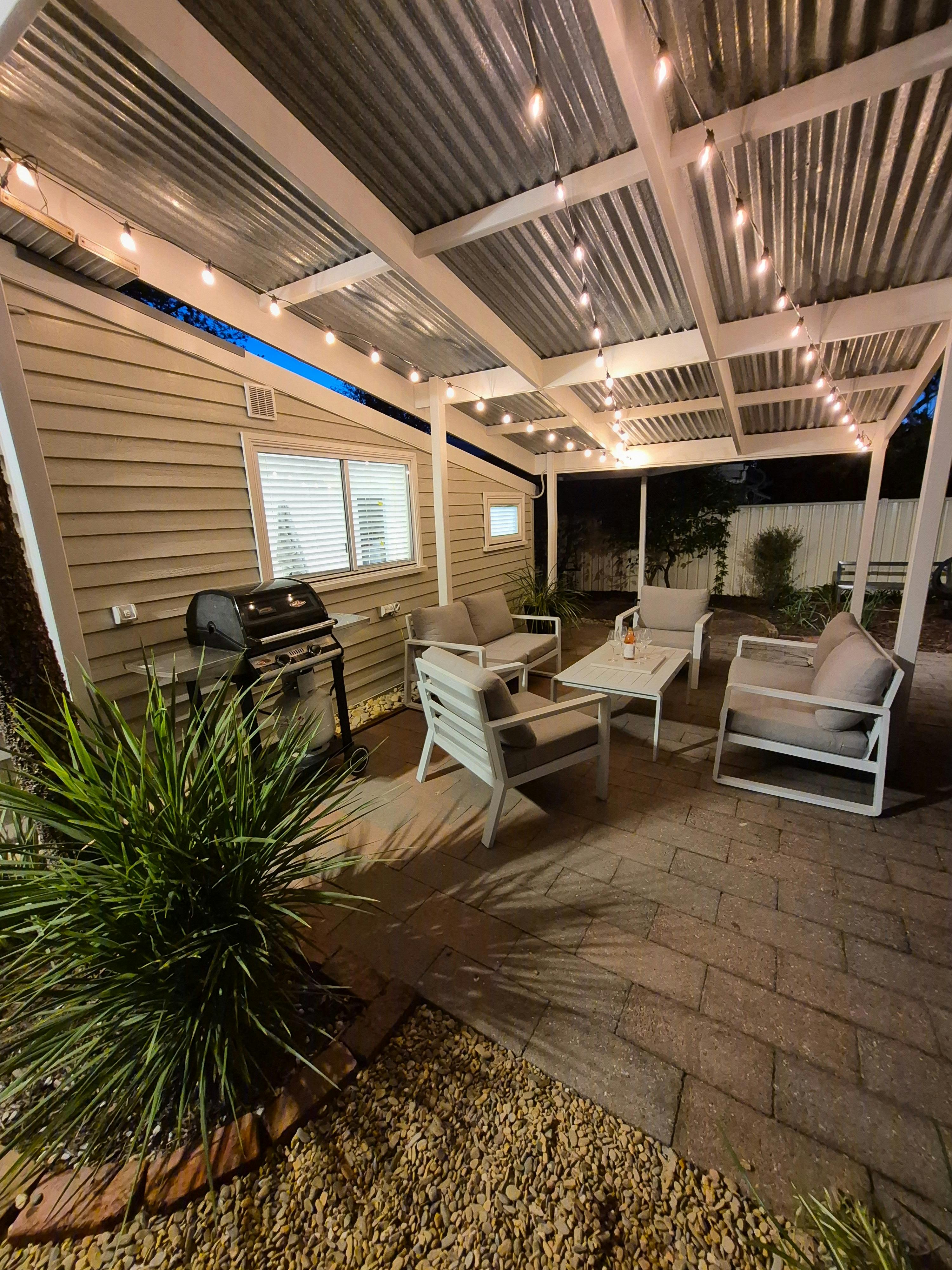 Outdoor area with chairs and a barbeque