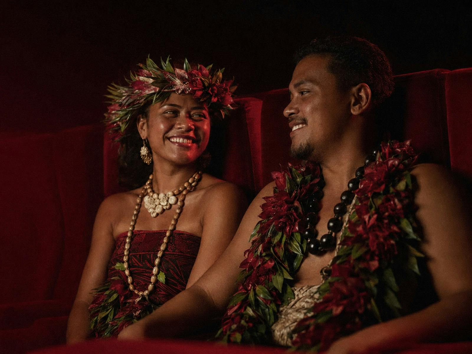 Pacific Island couple in theater with red seats