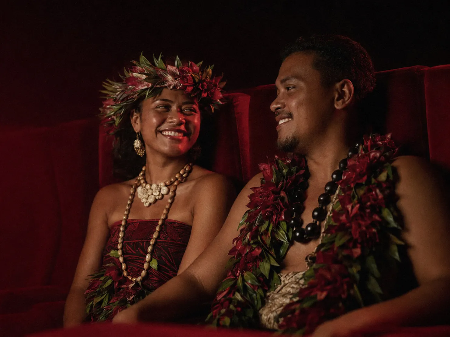 Pacific Island couple in theater with red seats
