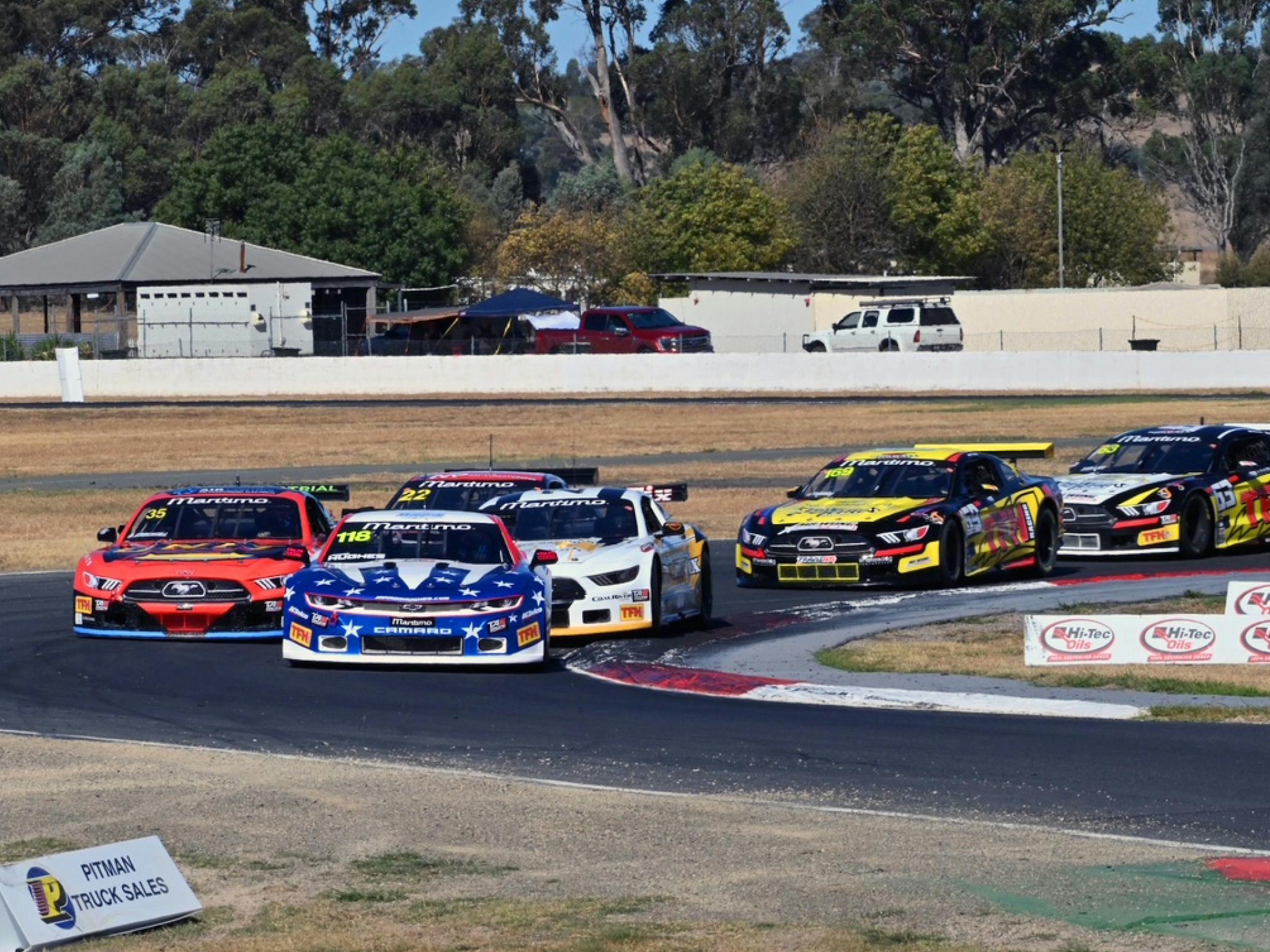 Group of TA2 racing cars going  around Winton Raceway