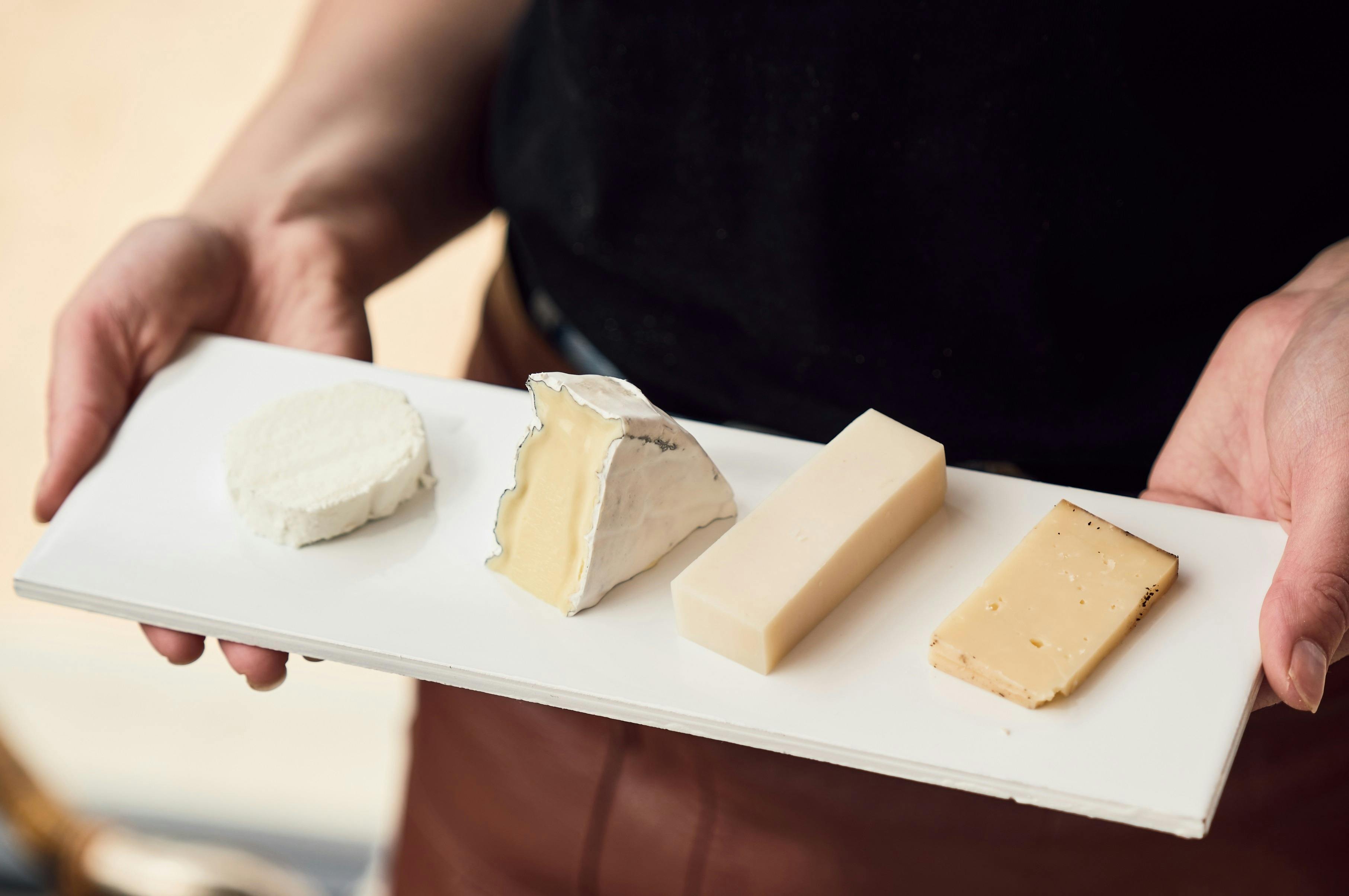 Waiter carrying cheese for tasting