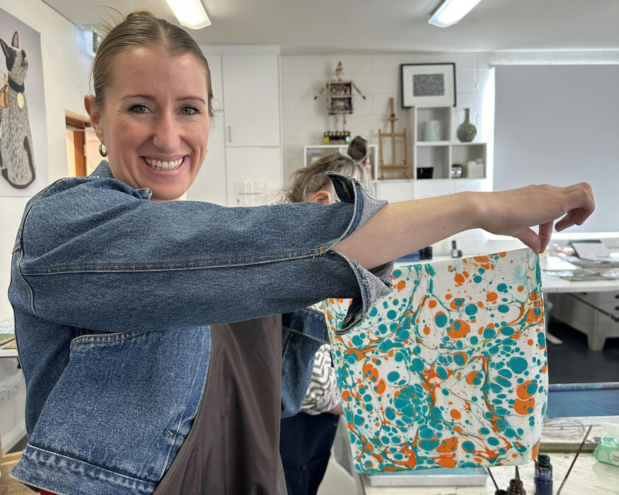 Woman holding marbled silk scarf