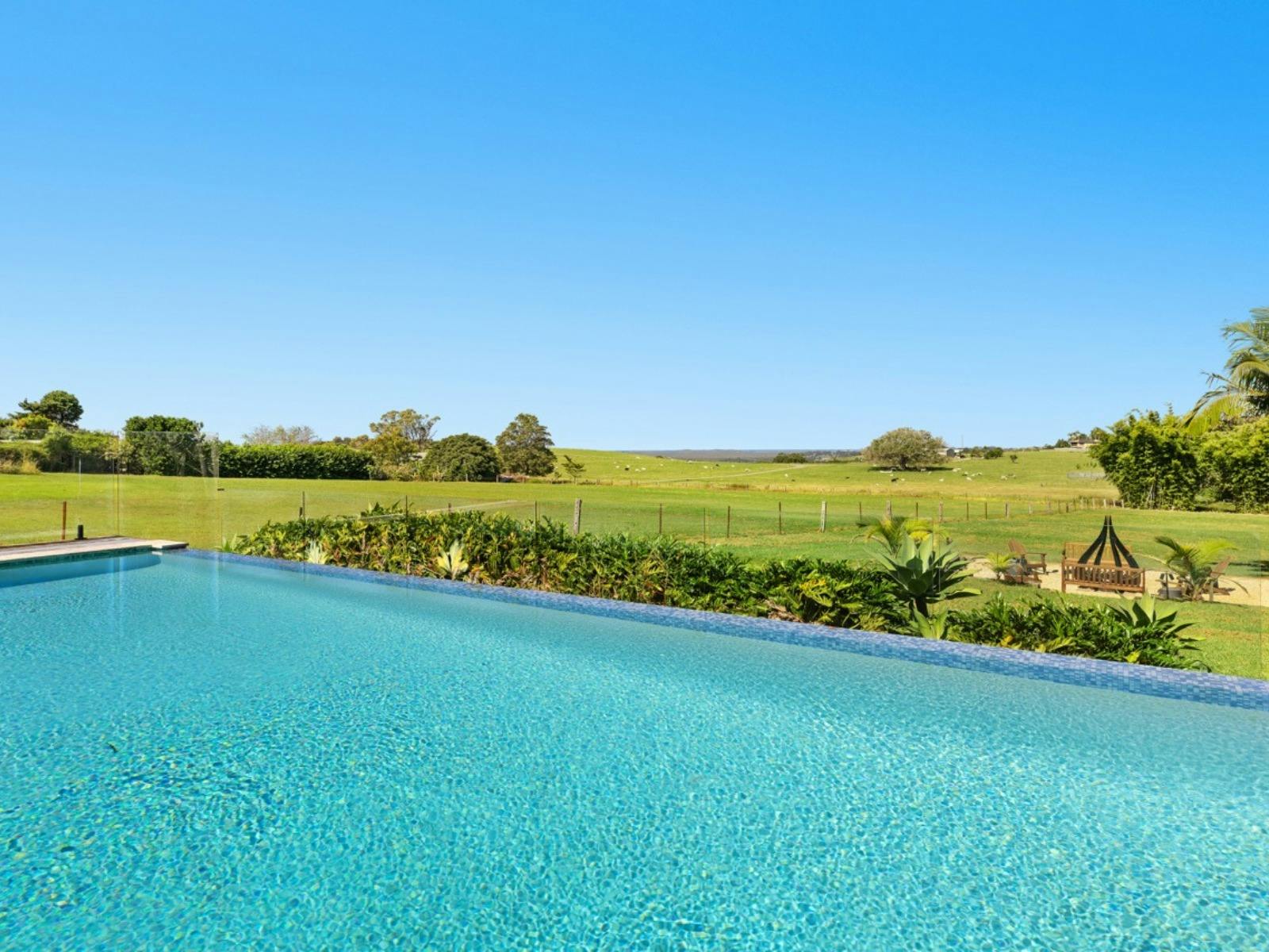 Infinity pool with uninterrupted views across rolling hinterland farmland.