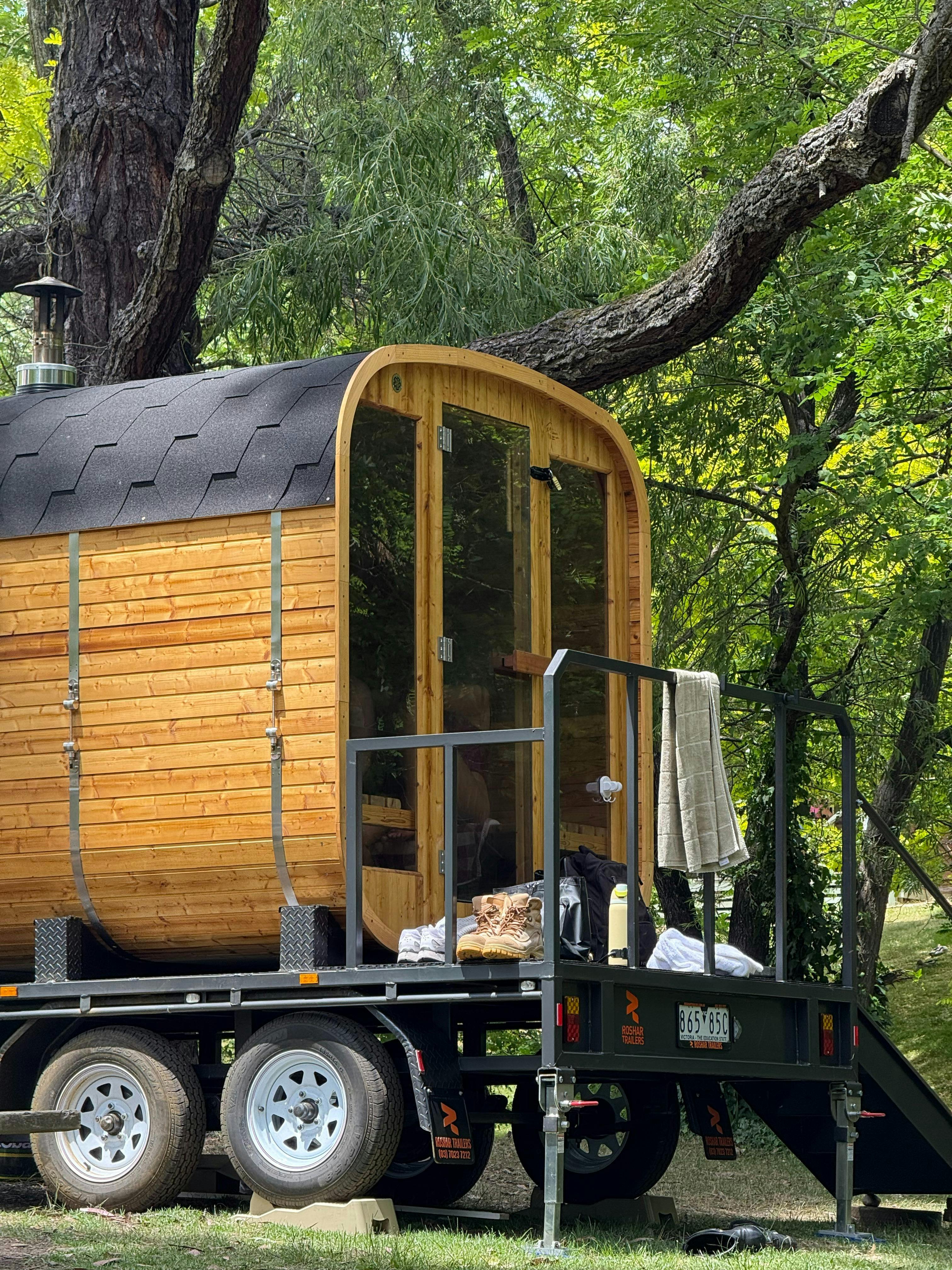 Mobile wood-fired sauna in Bright surrounded by bushland, offering a tranquil outdoor experience