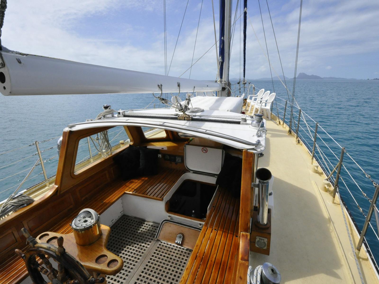 Spacious central cockpit features traditional teak woodwork & wide decks create a seafarers ambiance