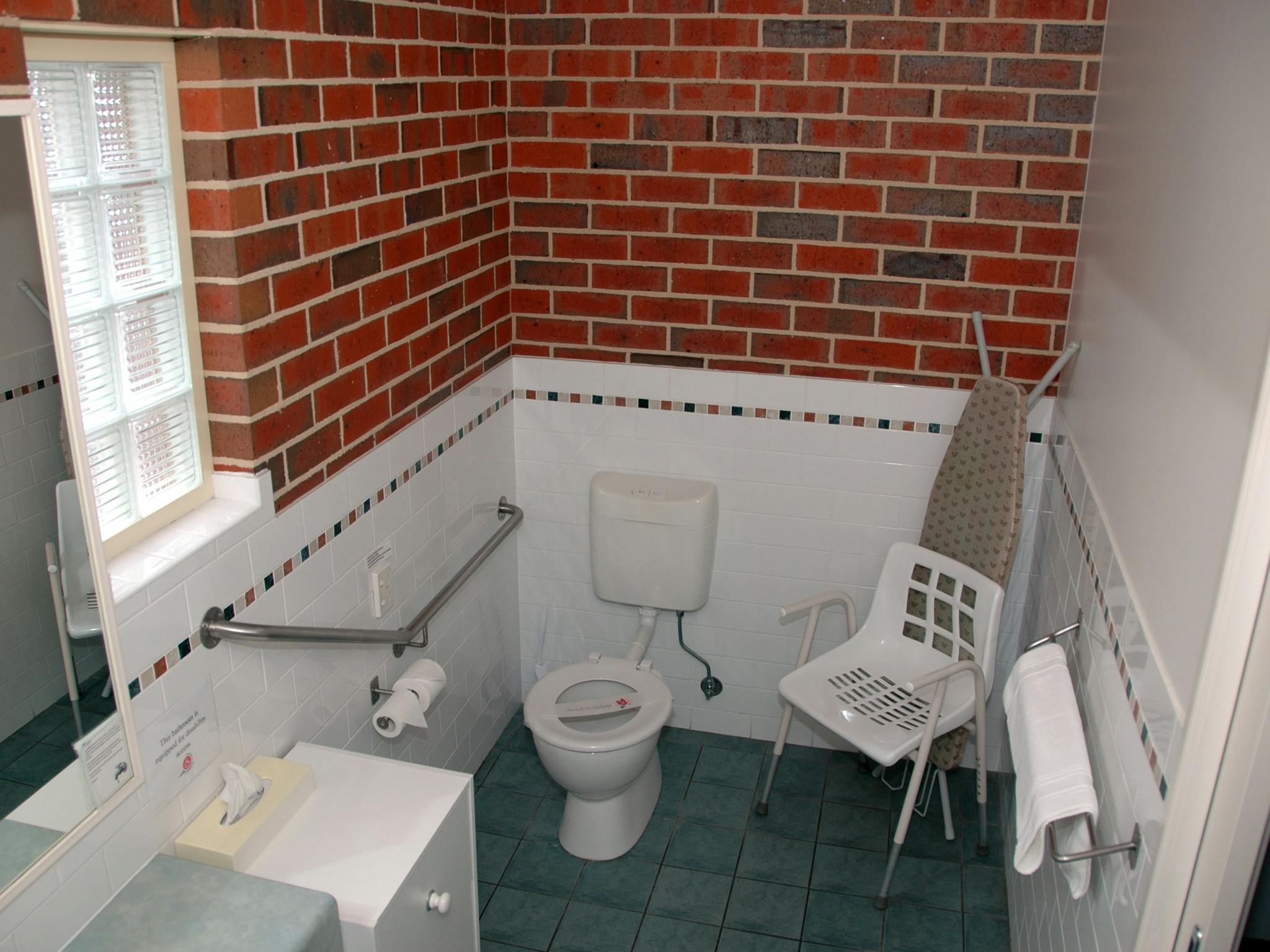 Bathroom with rails and shower chair