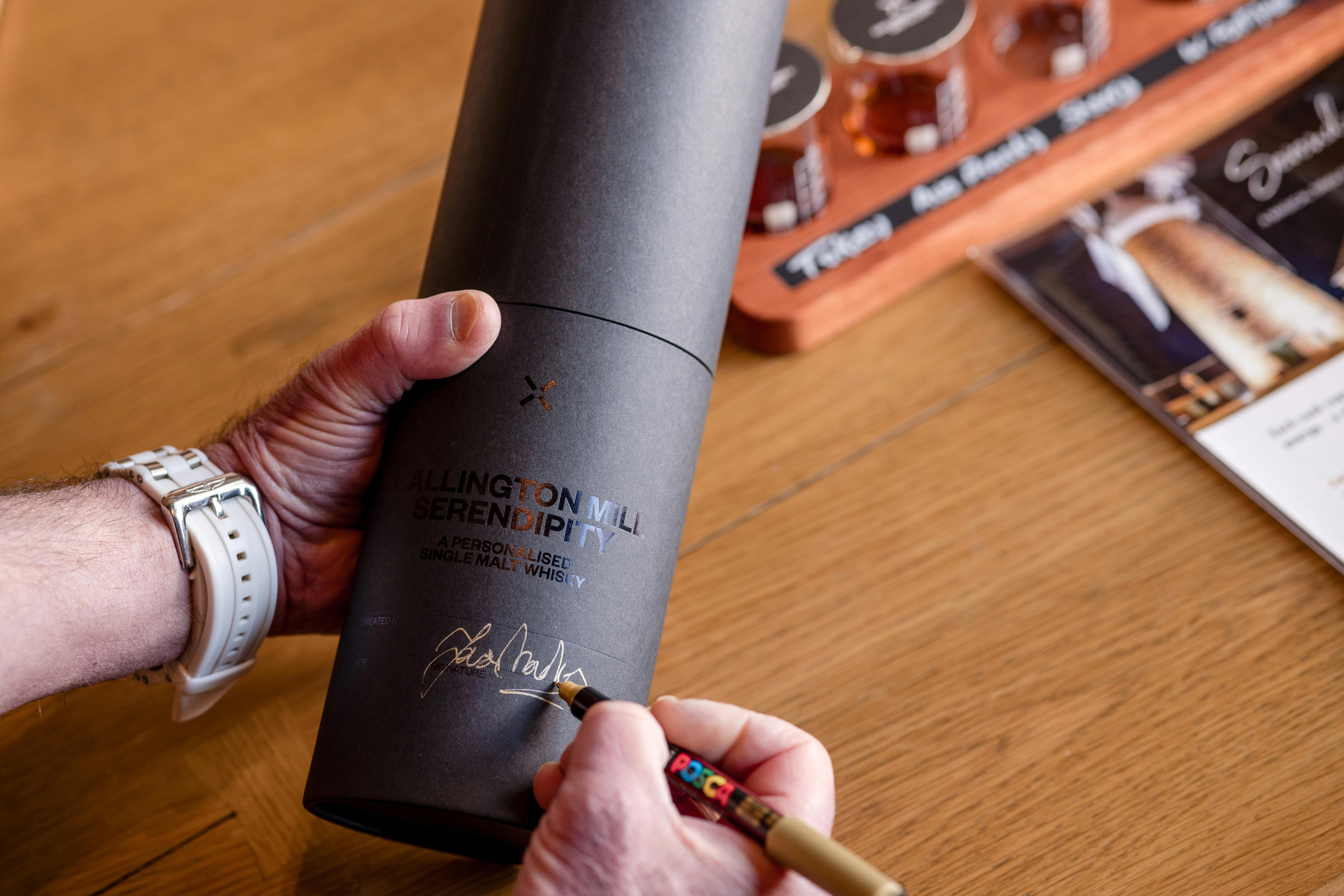Two hands holding a black bottle sleeve