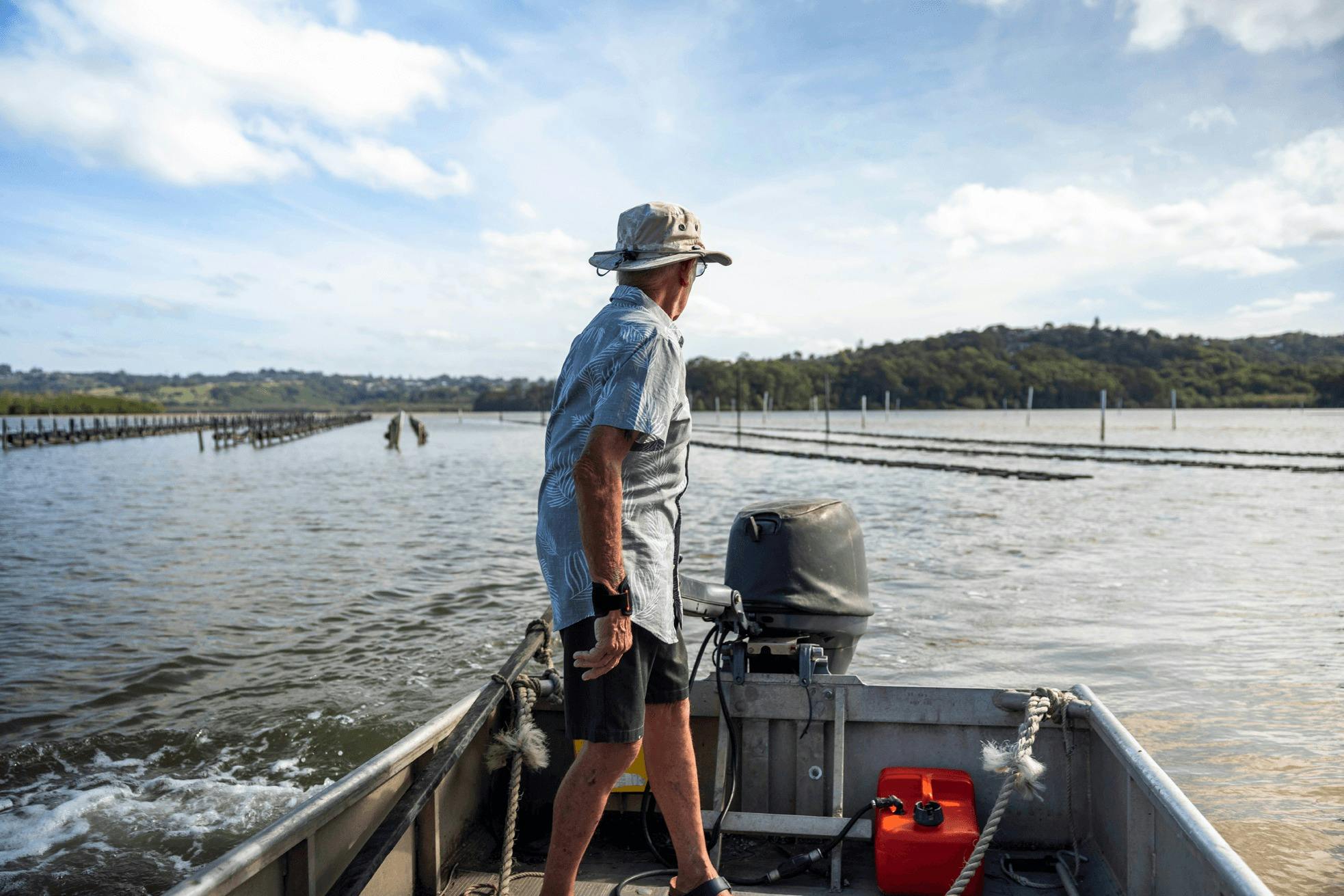 Tweed River oyster farmer steers his boat past the oyster lease