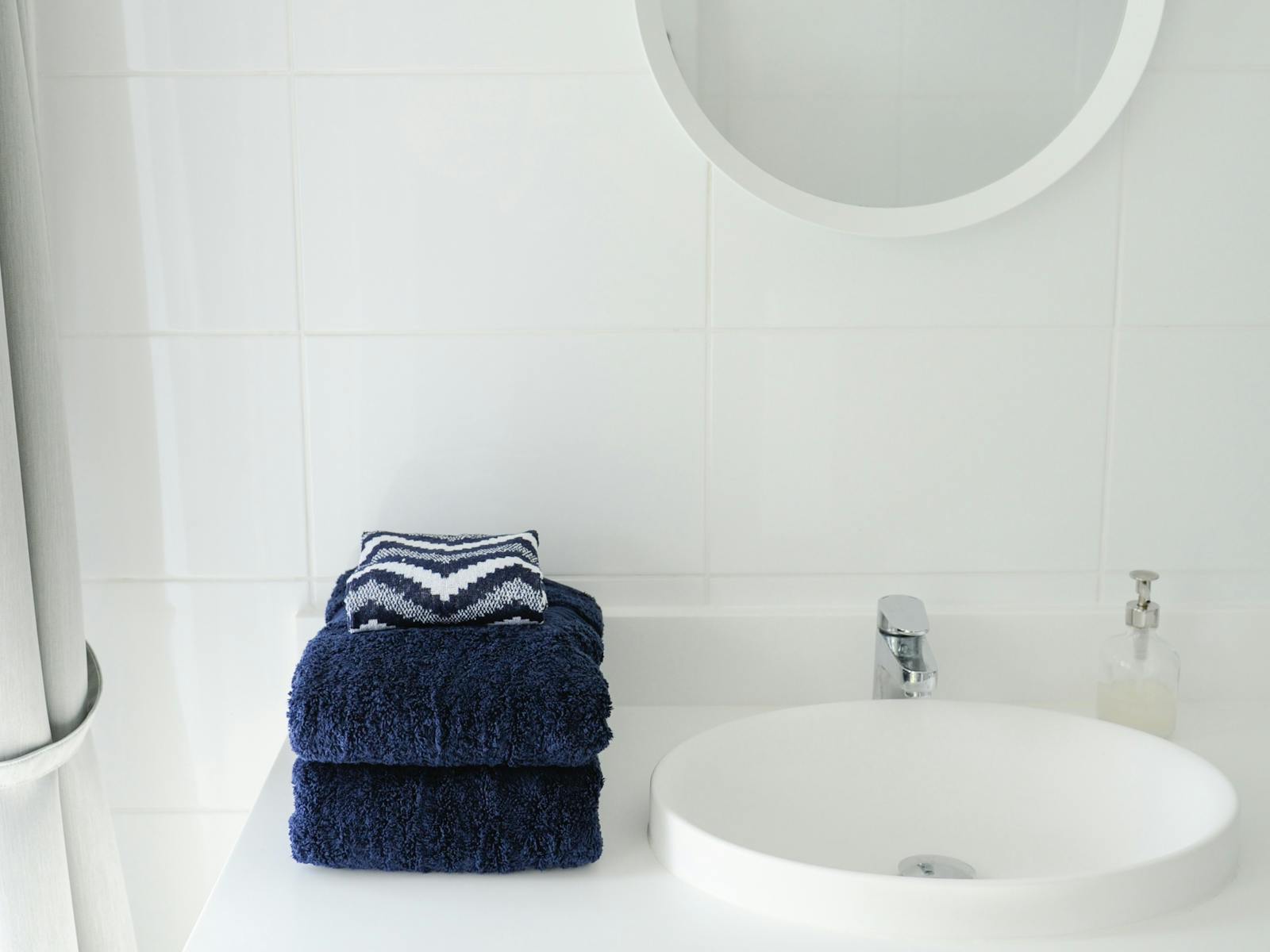 Main bathroom with shower over deep bath tub and washer/dryer.