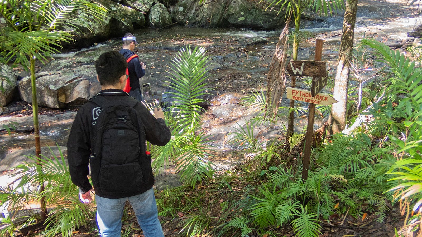 Two young guests are having an Instagram moment in the waterfall of Bellthorpe Stays Two young guests are having an Instagram moment in the waterfall of Bellthorpe Stays