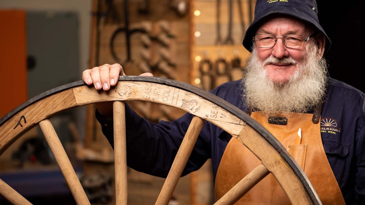 wheelwright Kerry Riehl displaying one of his crafted wheels. wheelwright Kerry Riehl displaying one of his crafted wheels.