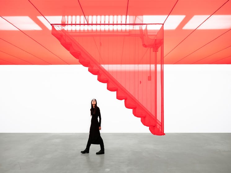 A person looking at an architectural installation.