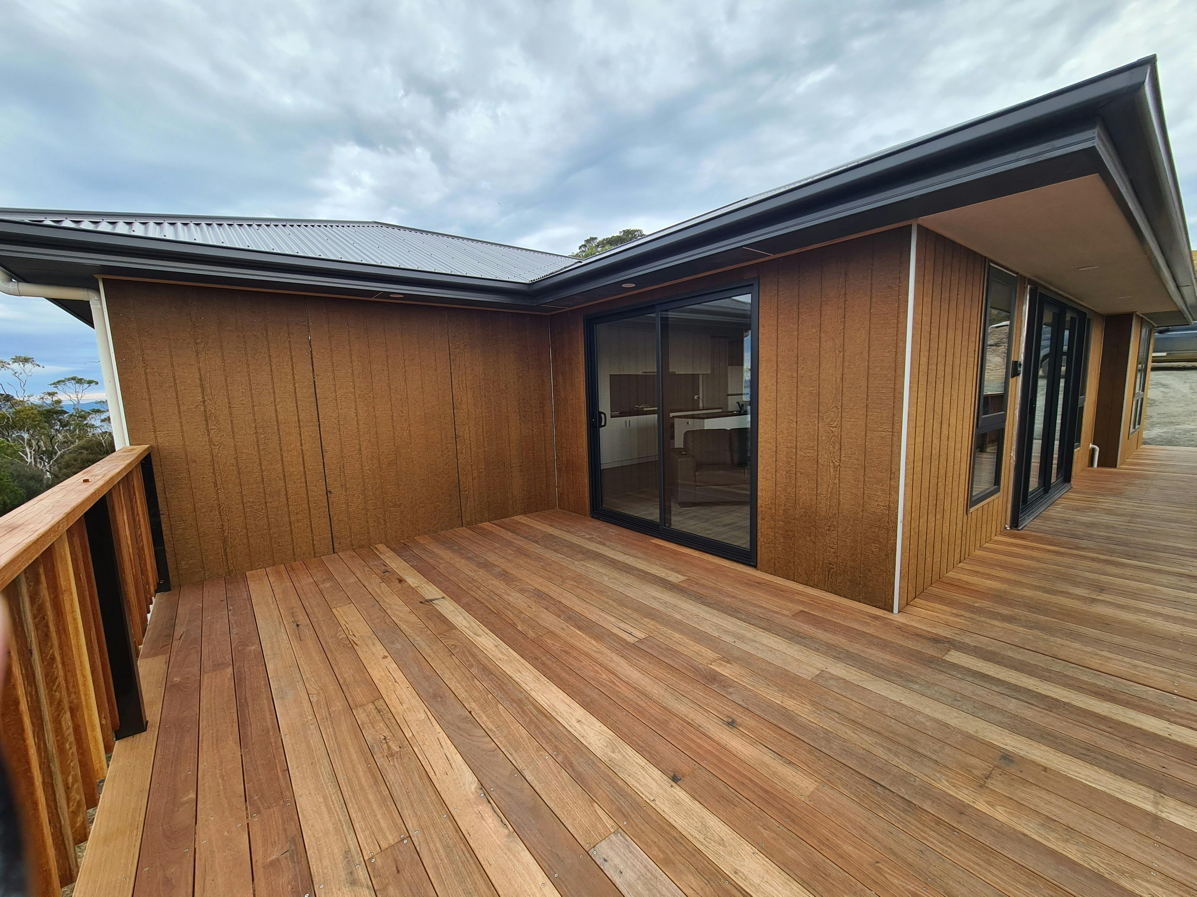 Wooden cabin exterior and private deck at Mt Rumney Escapes