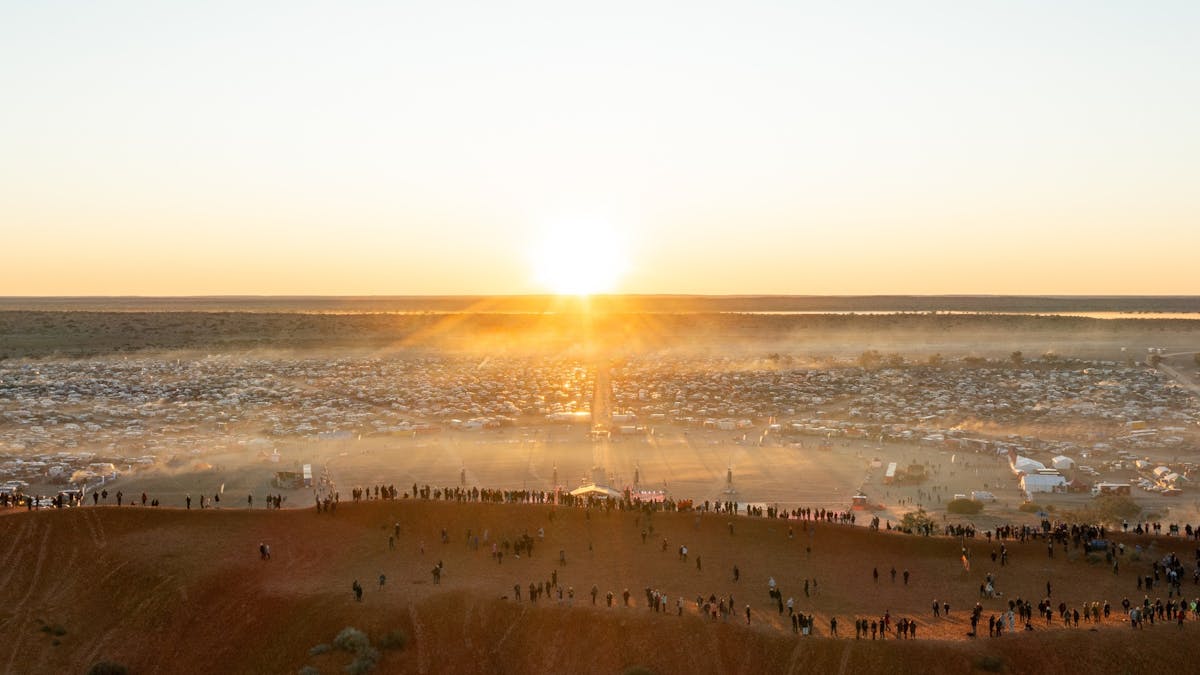 Aerial view of Big Red Bash campground at sunrise with the iconic red sand dunes of the Simpson Dese