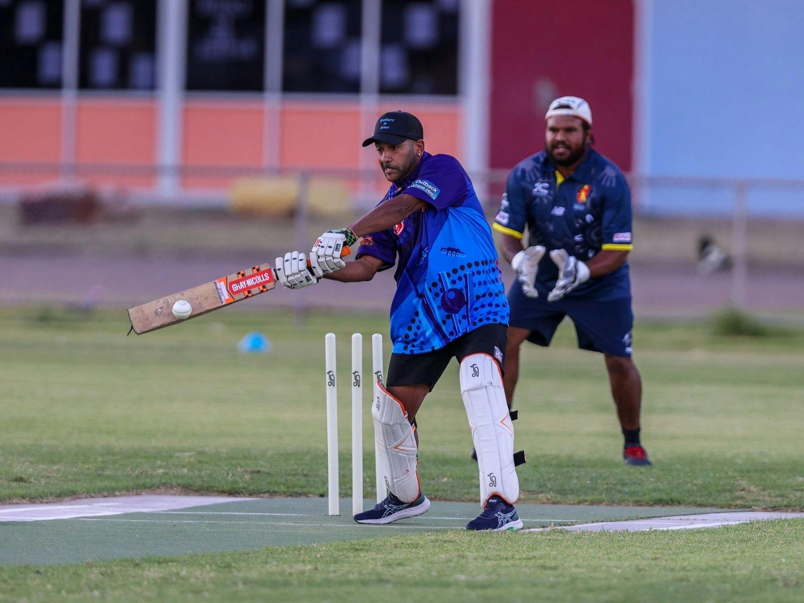 Indigenous male playing cricket