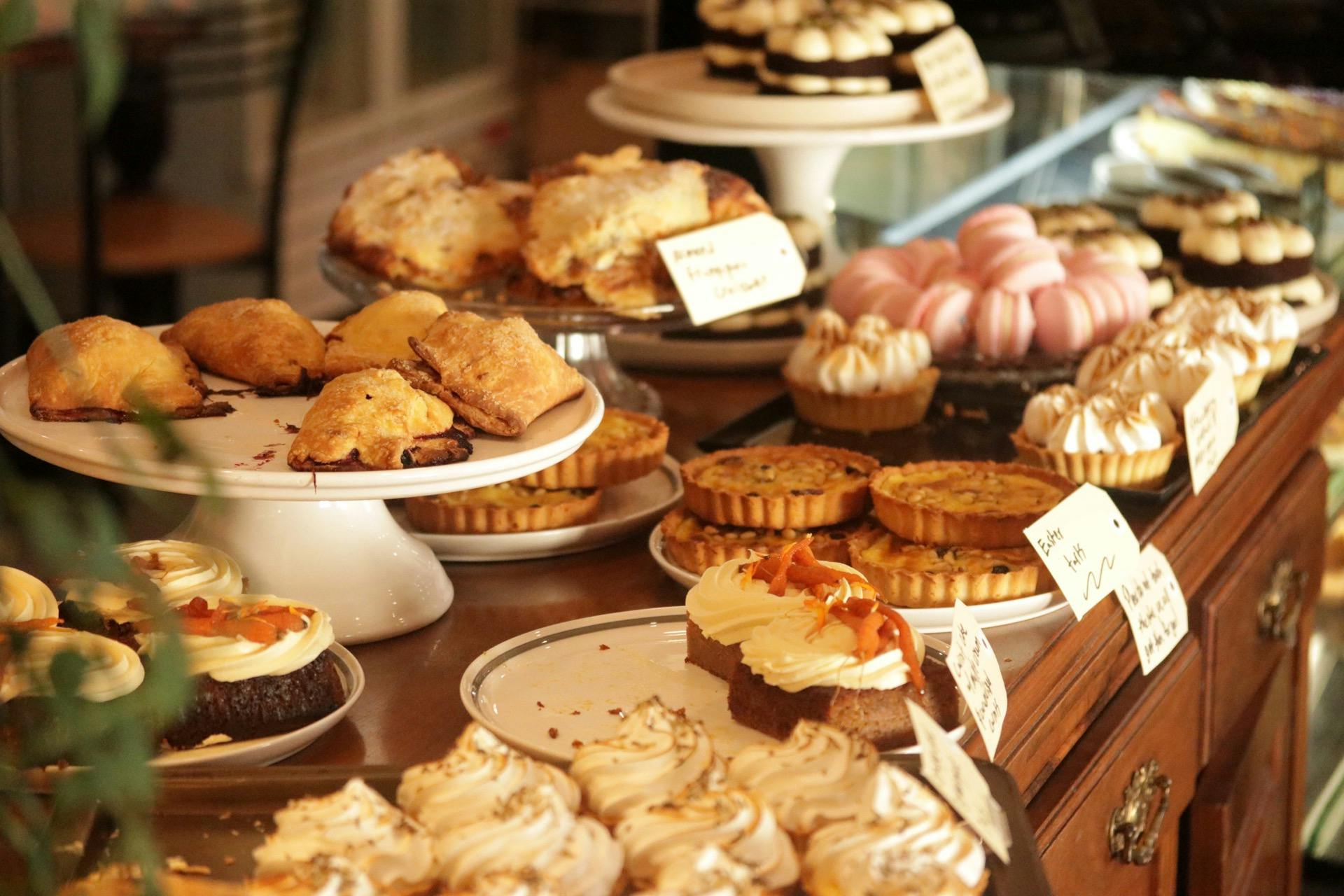A selection of cakes displayed on stands and plate