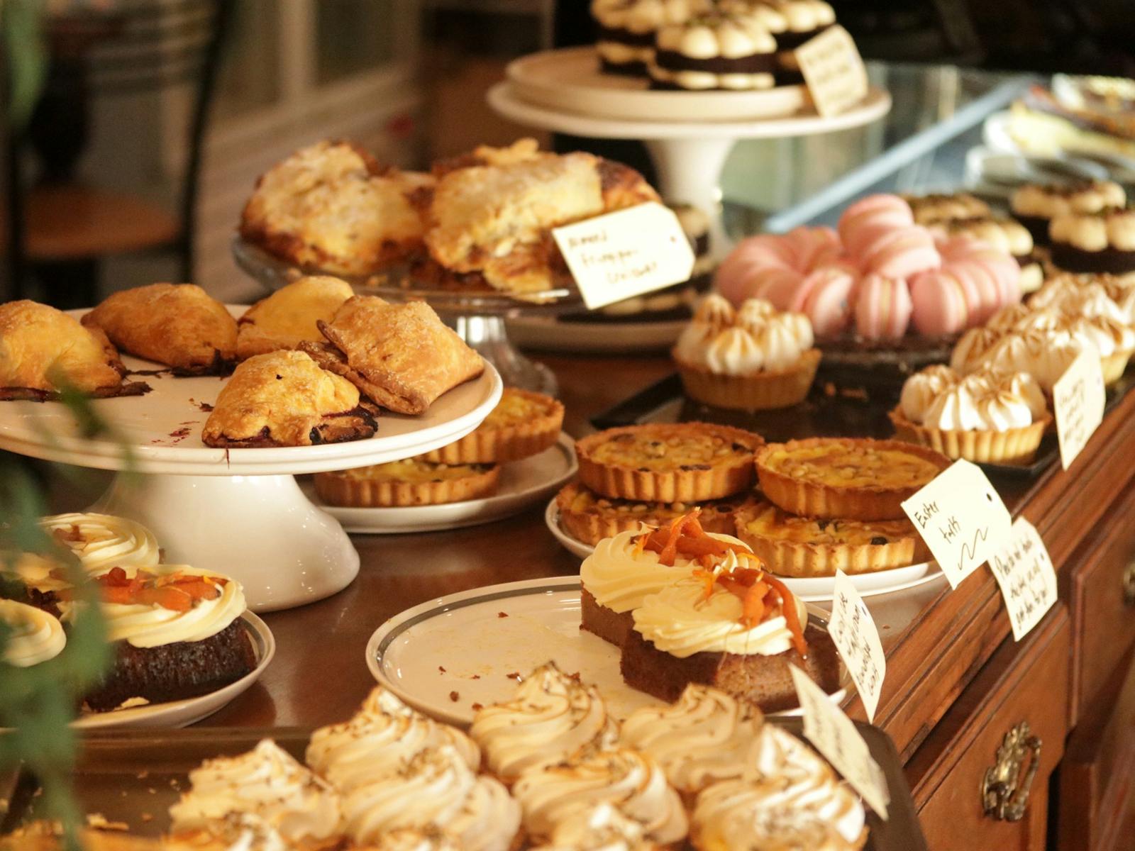A selection of cakes displayed on stands and plate