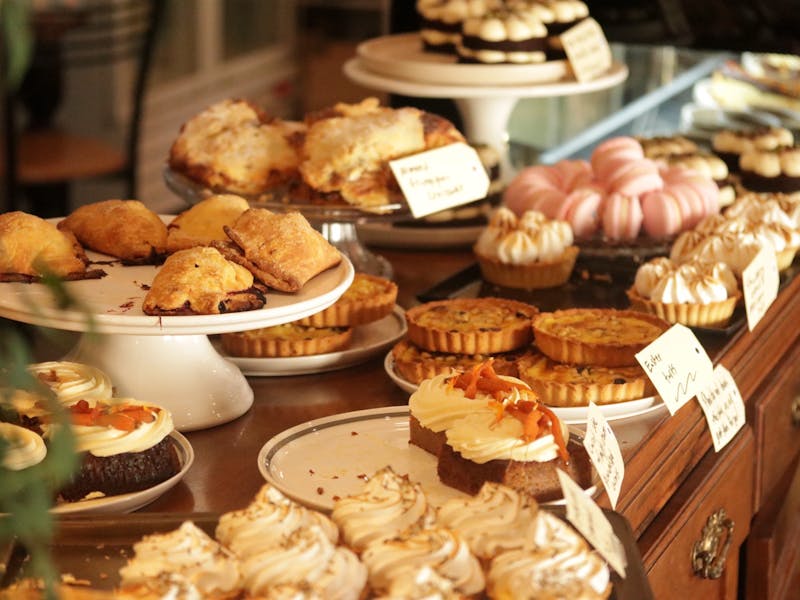 A selection of cakes displayed on stands and plate