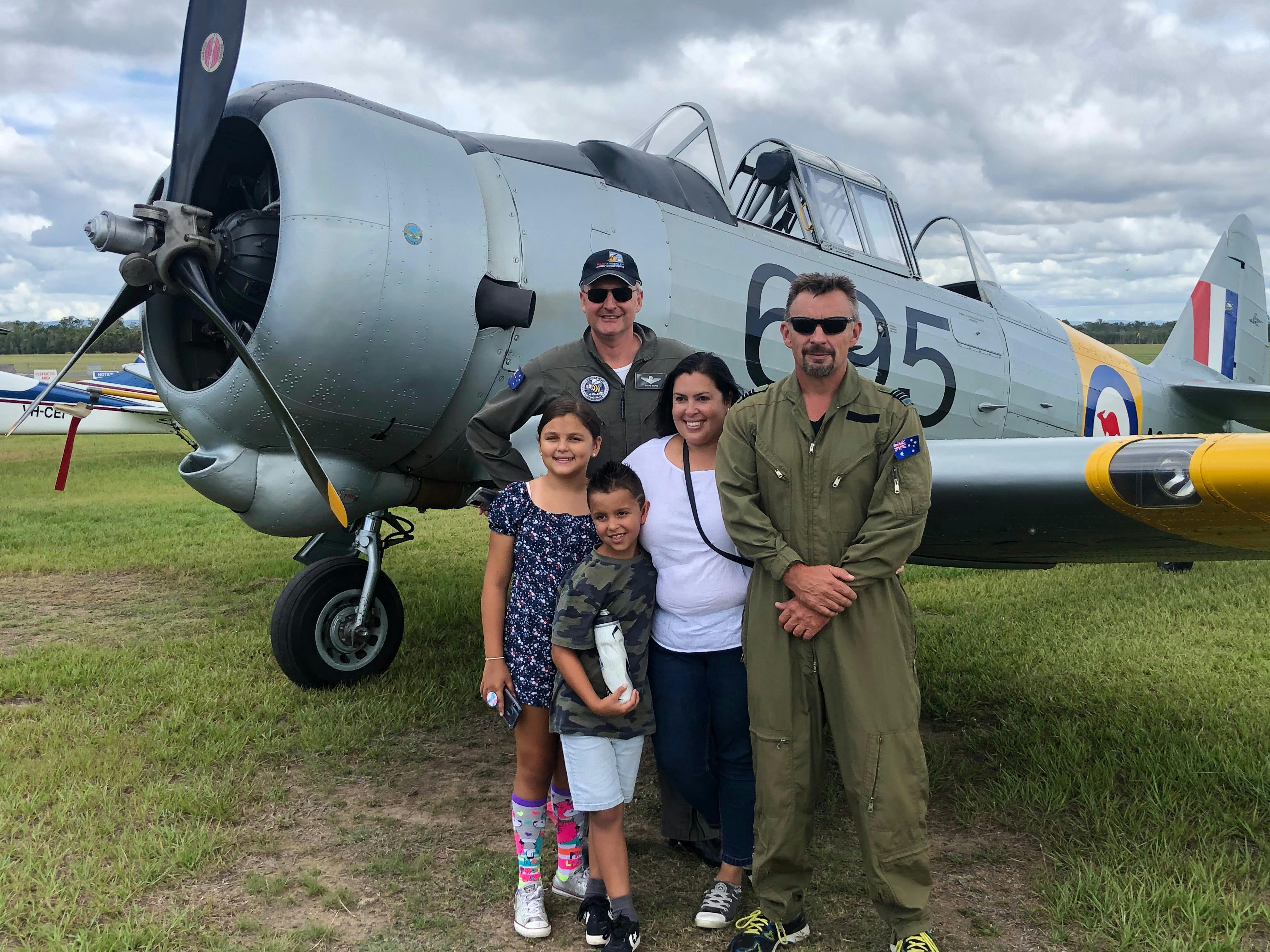 The family waves goodbye to Dad as he goes for his Birthday flight