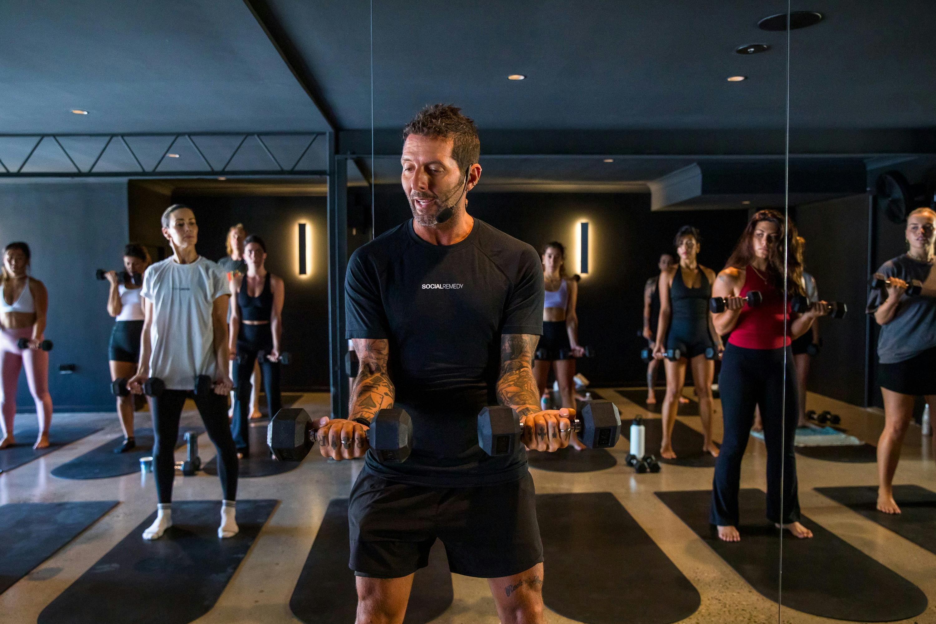 People doing pilates with weights