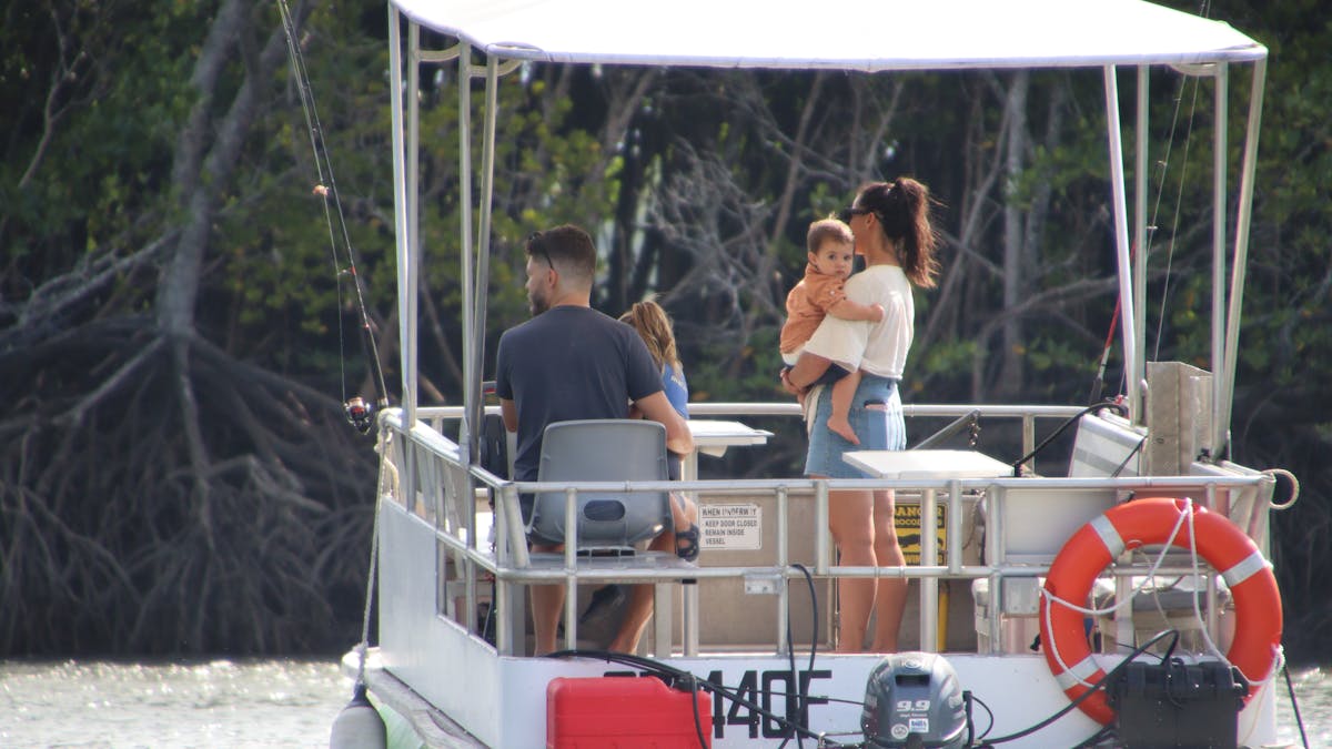 Young family with 2 adults and 2 toddlers enjoying a day out on the Trinity Inlet